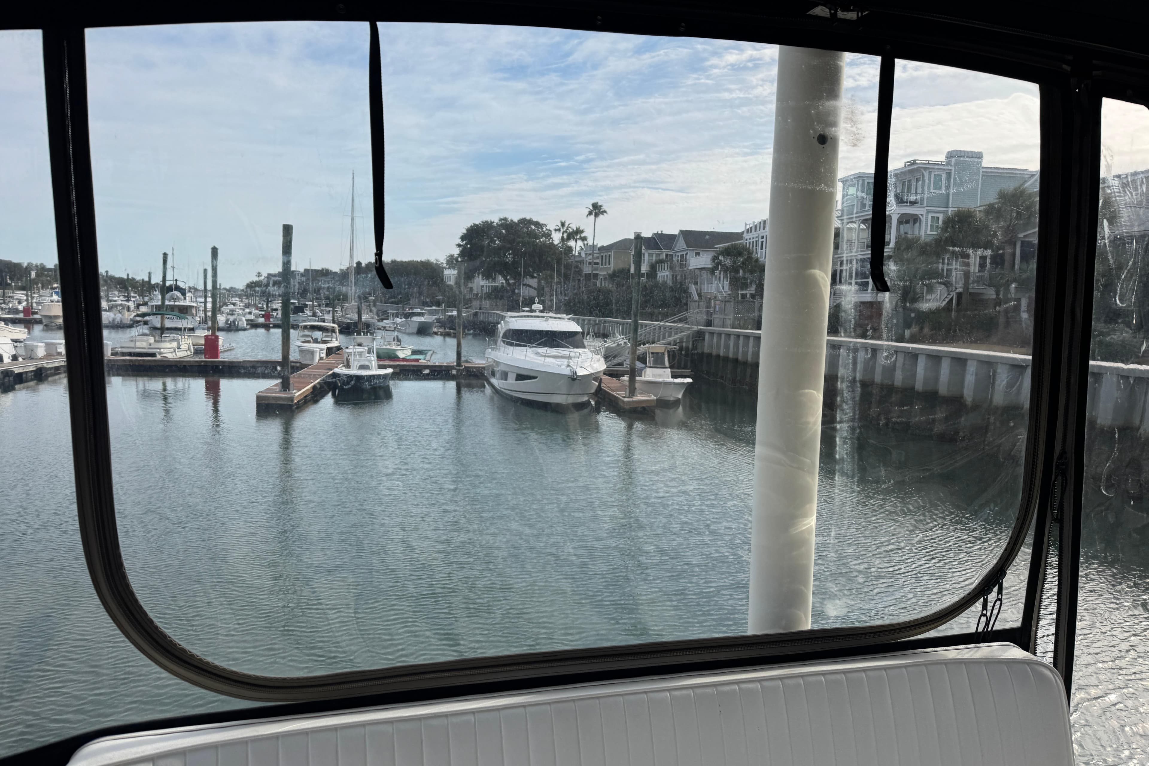View from Ellis 36 Flybridge, 2001 model, overlooking marina with boats and waterfront homes.