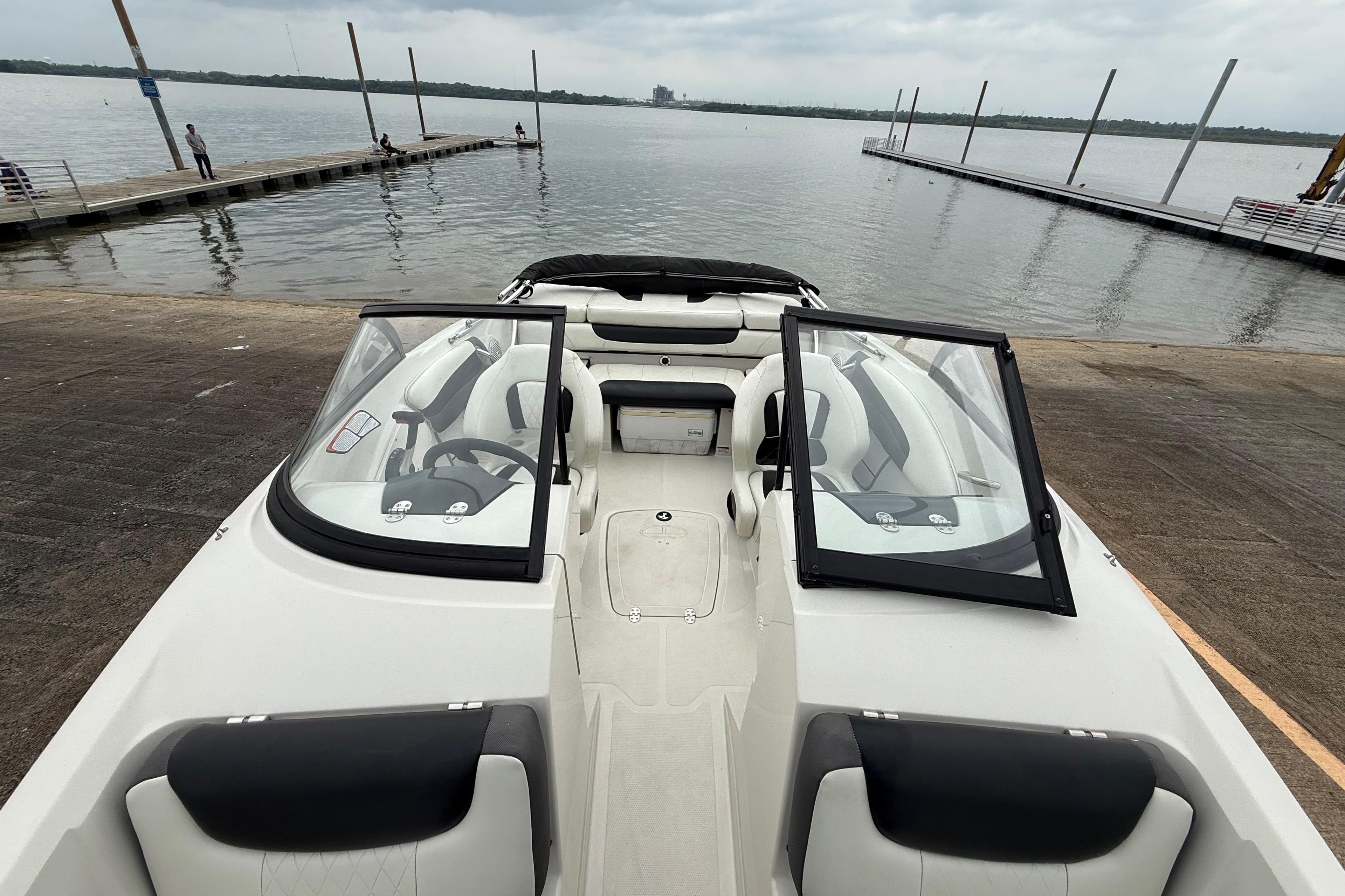 2016 Tahoe 500 TF boat docked at a lakeside marina with open windshield.