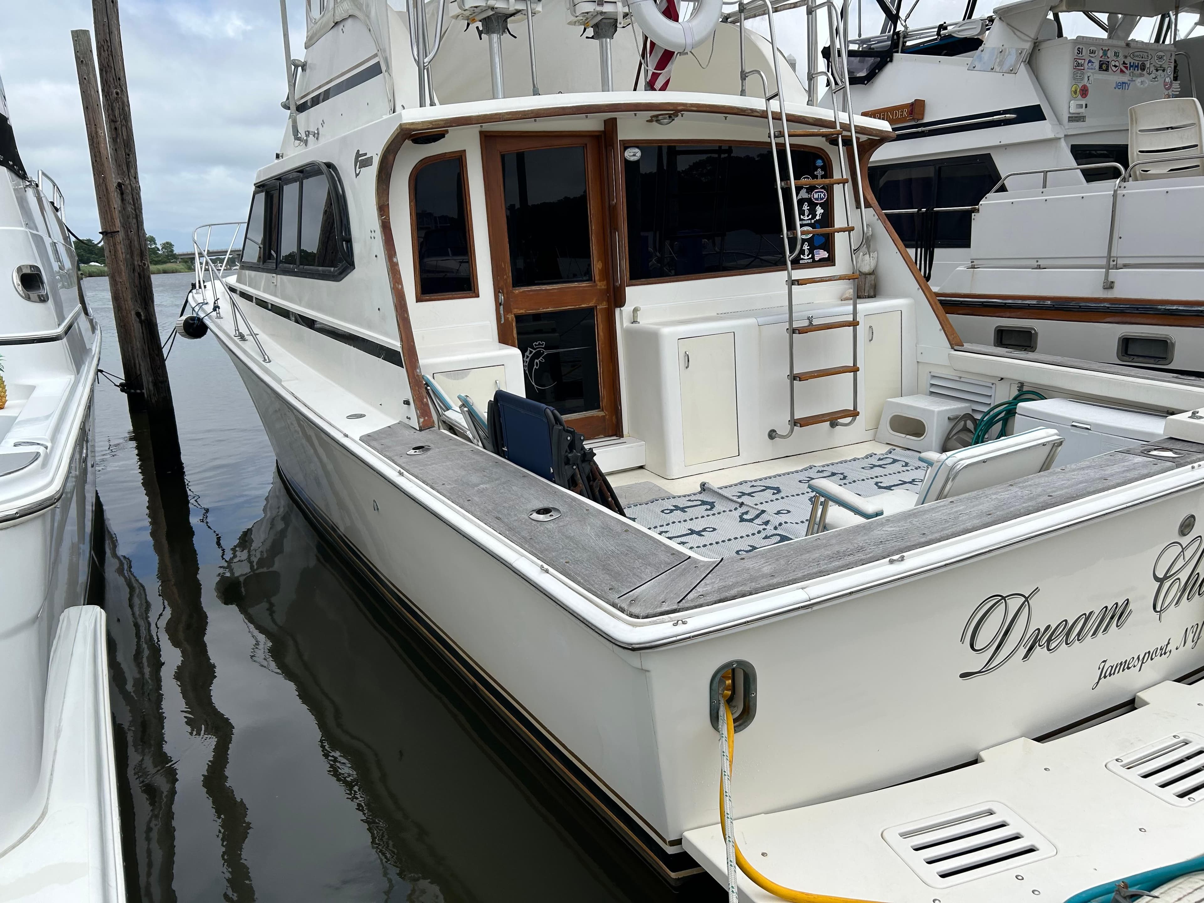 1990 Egg Harbor 42 Golden Egg yacht docked, featuring a spacious deck and elegant design.