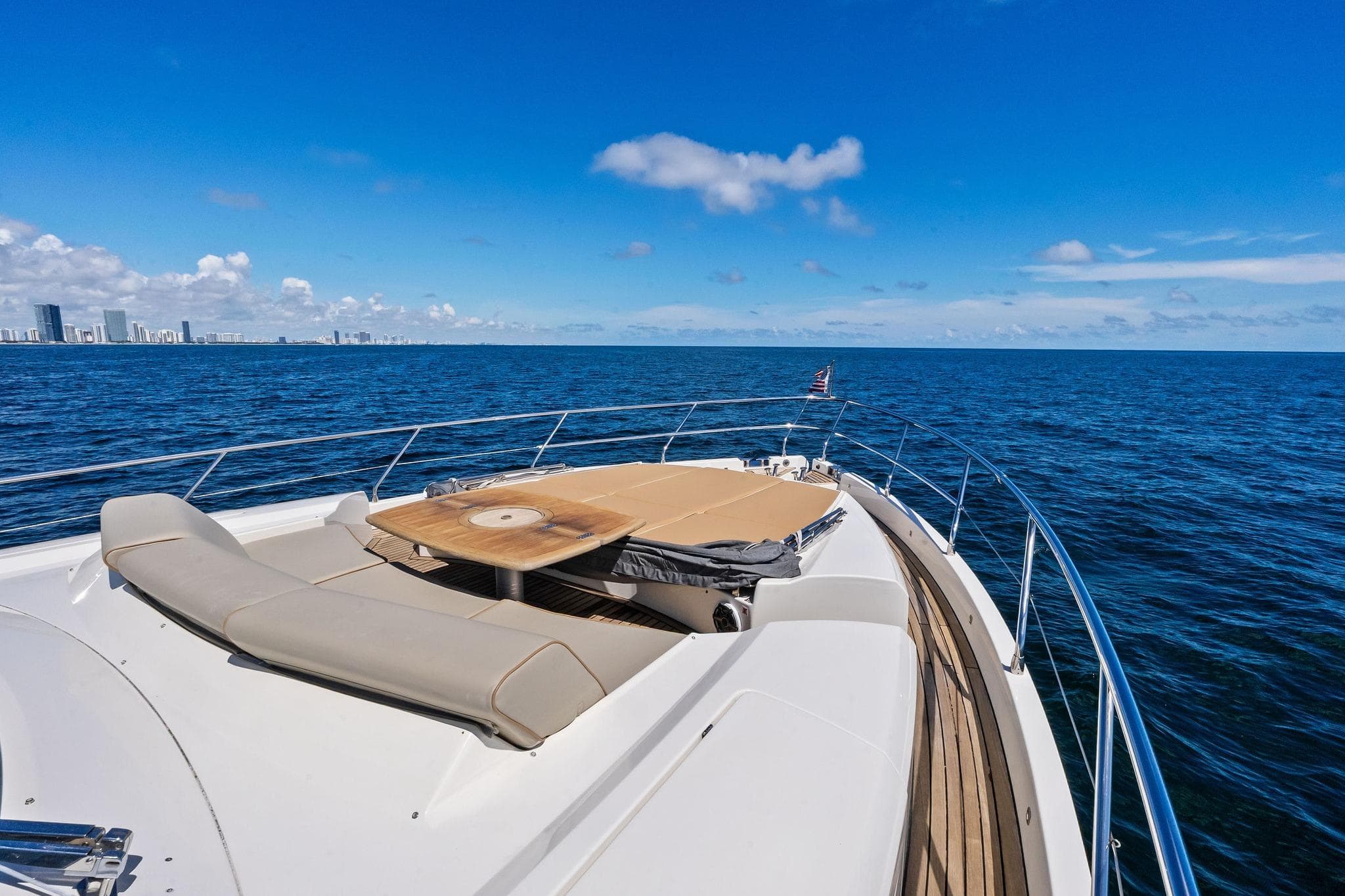 Luxury Absolute 64 yacht cruising on open sea, clear blue sky, 2013 model.
