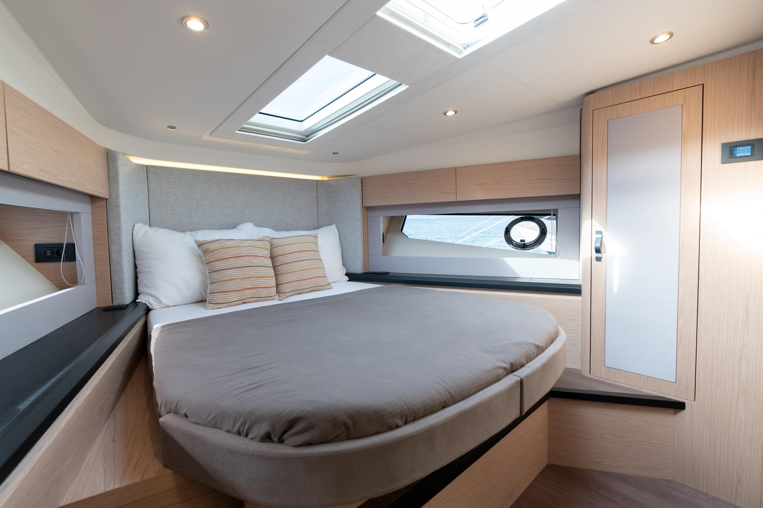 Luxurious cabin interior of 2022 Monte Carlo 52 yacht with skylight and modern design.