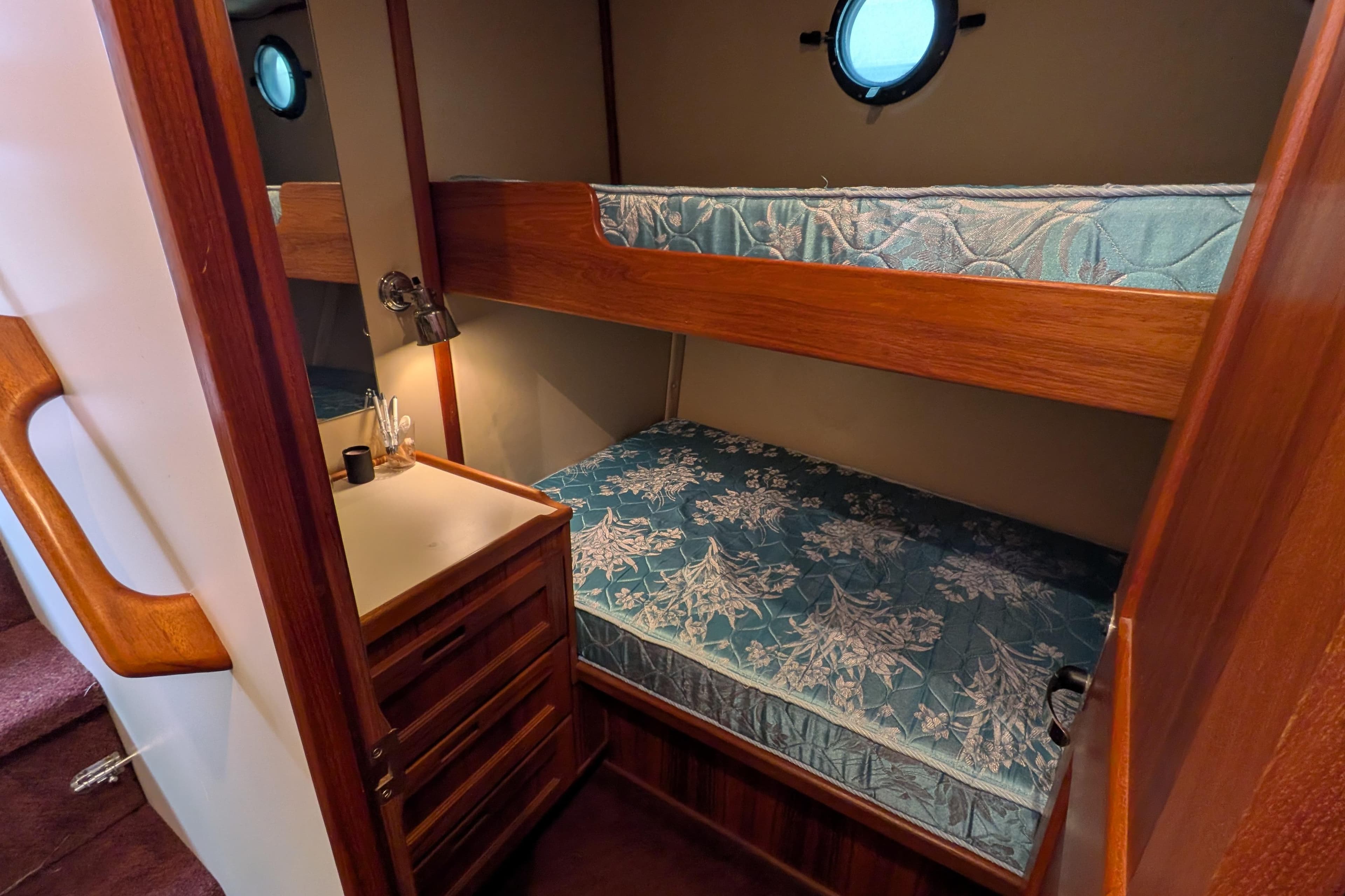 Cozy cabin with bunk beds in a 2000 Nordic Tug 37 boat interior.