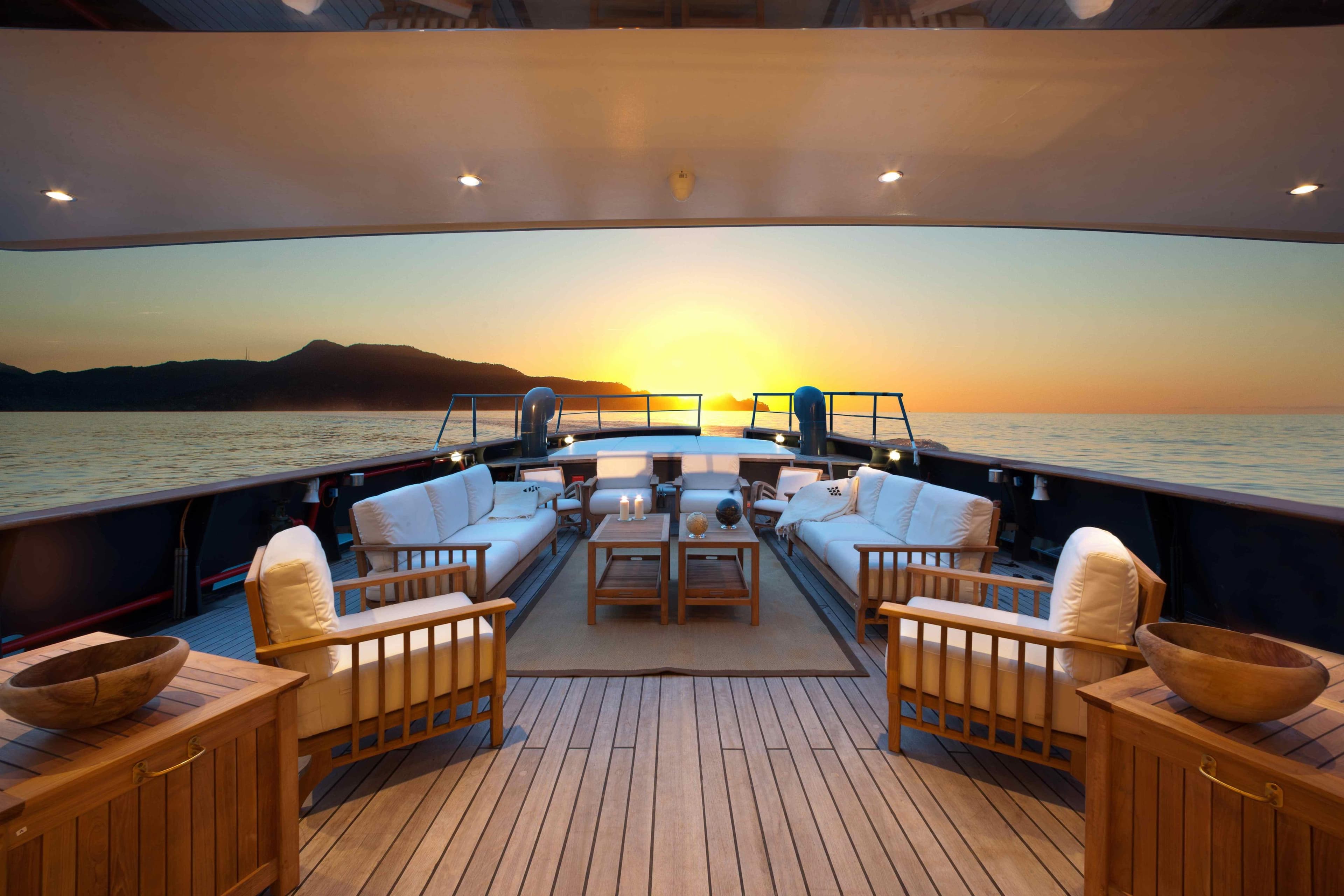 Luxurious Benetti Explorer trawler 30m yacht deck with sunset view, 2013 model.