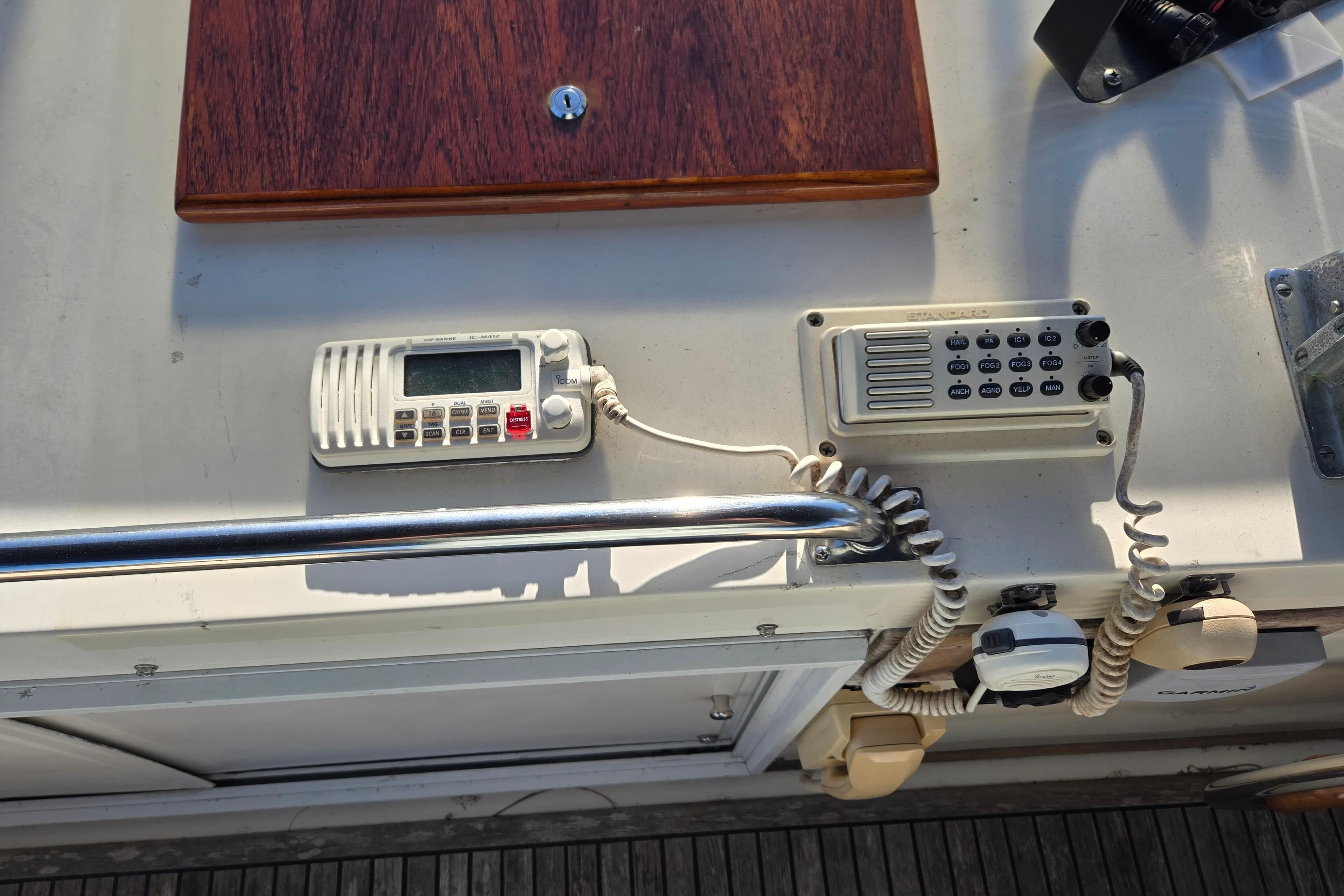 Control panel on a 1992 Grand Banks 46 Classic yacht, featuring communication devices.