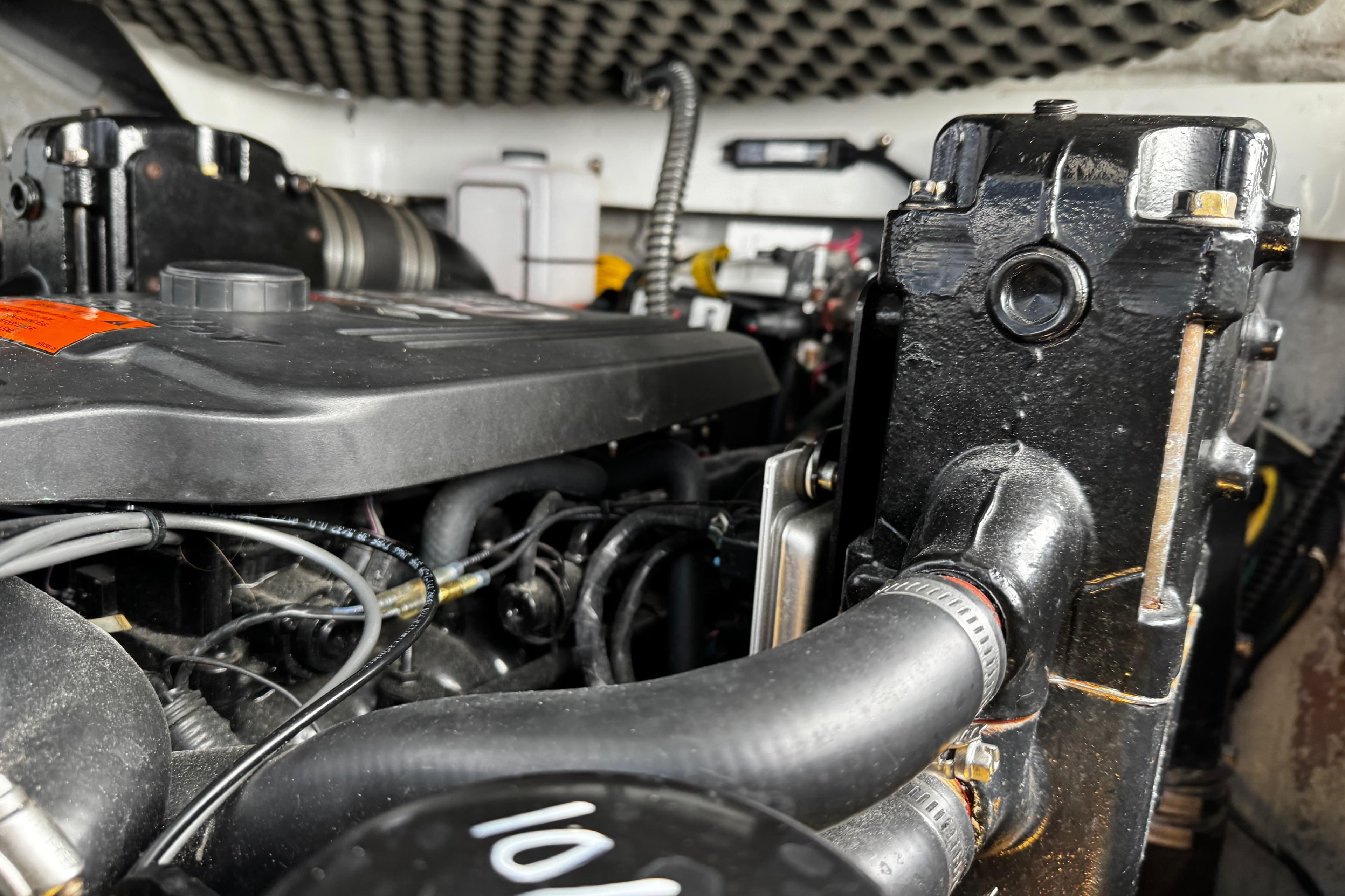 Engine compartment of a 2004 Crownline 250 CR boat, showcasing detailed mechanical components.
