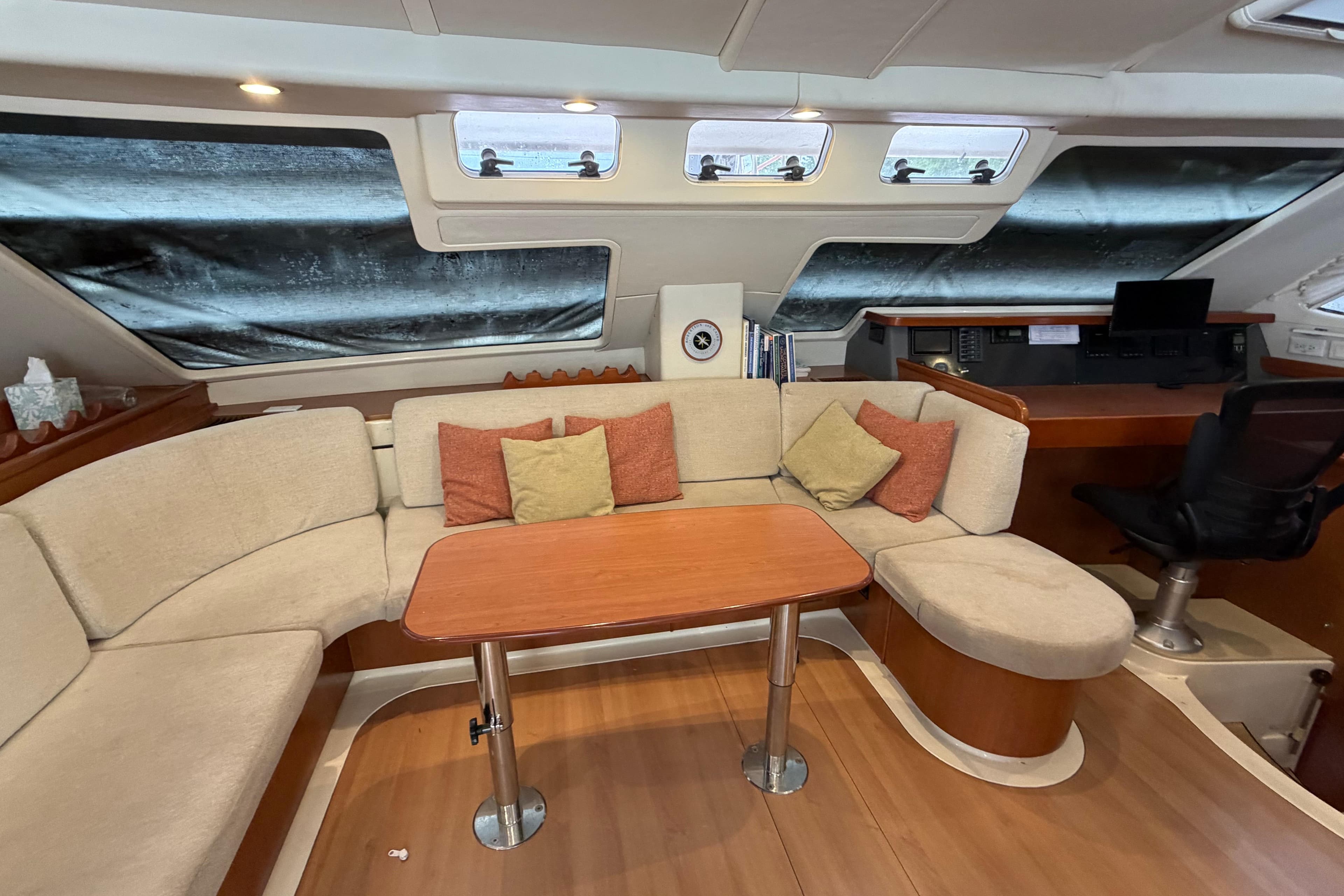 Luxurious 2007 Leopard 46 yacht interior with cozy seating and navigation area.