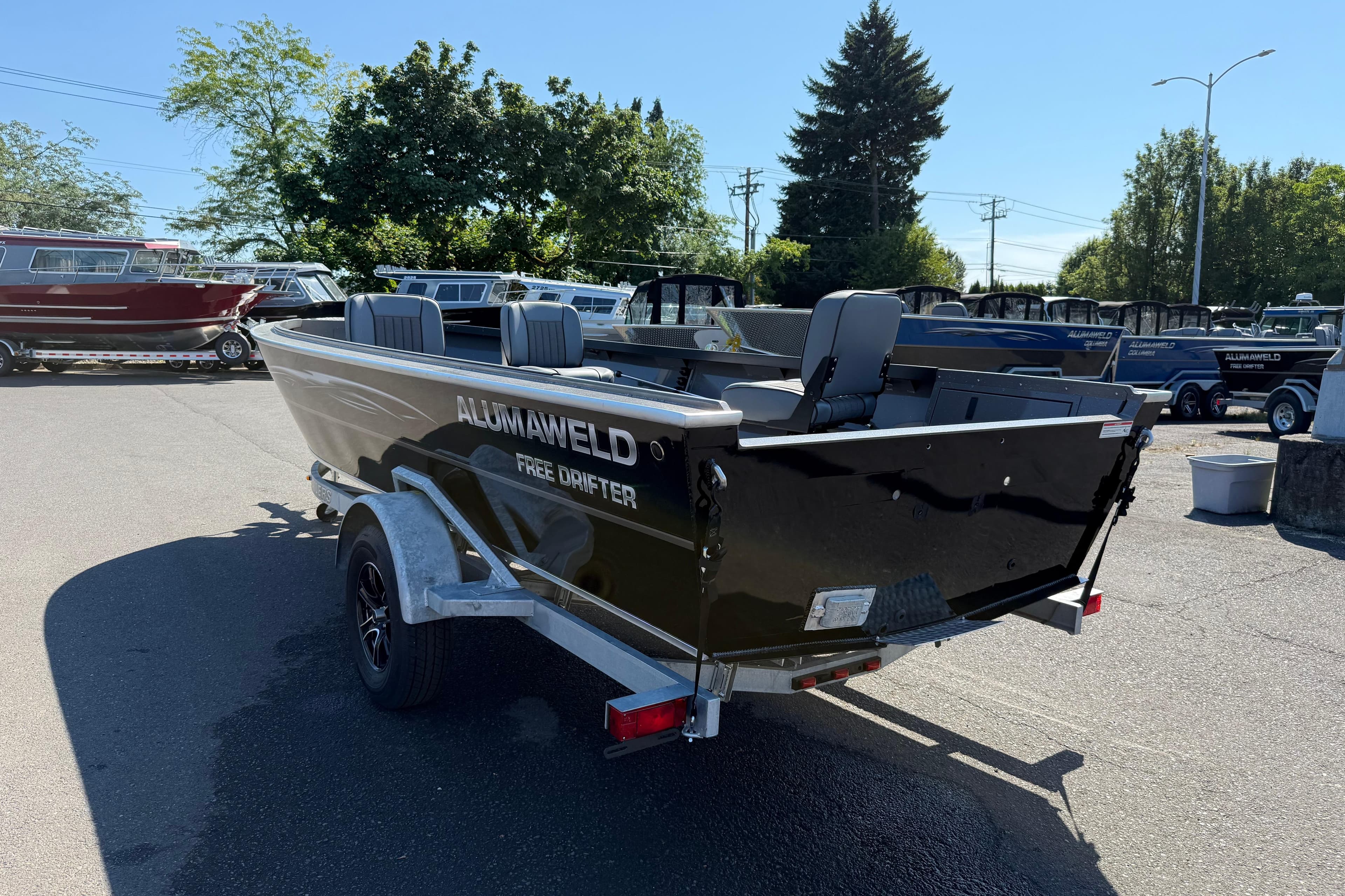 2025 Alumaweld Free Drifter 20 boat on trailer in outdoor lot.