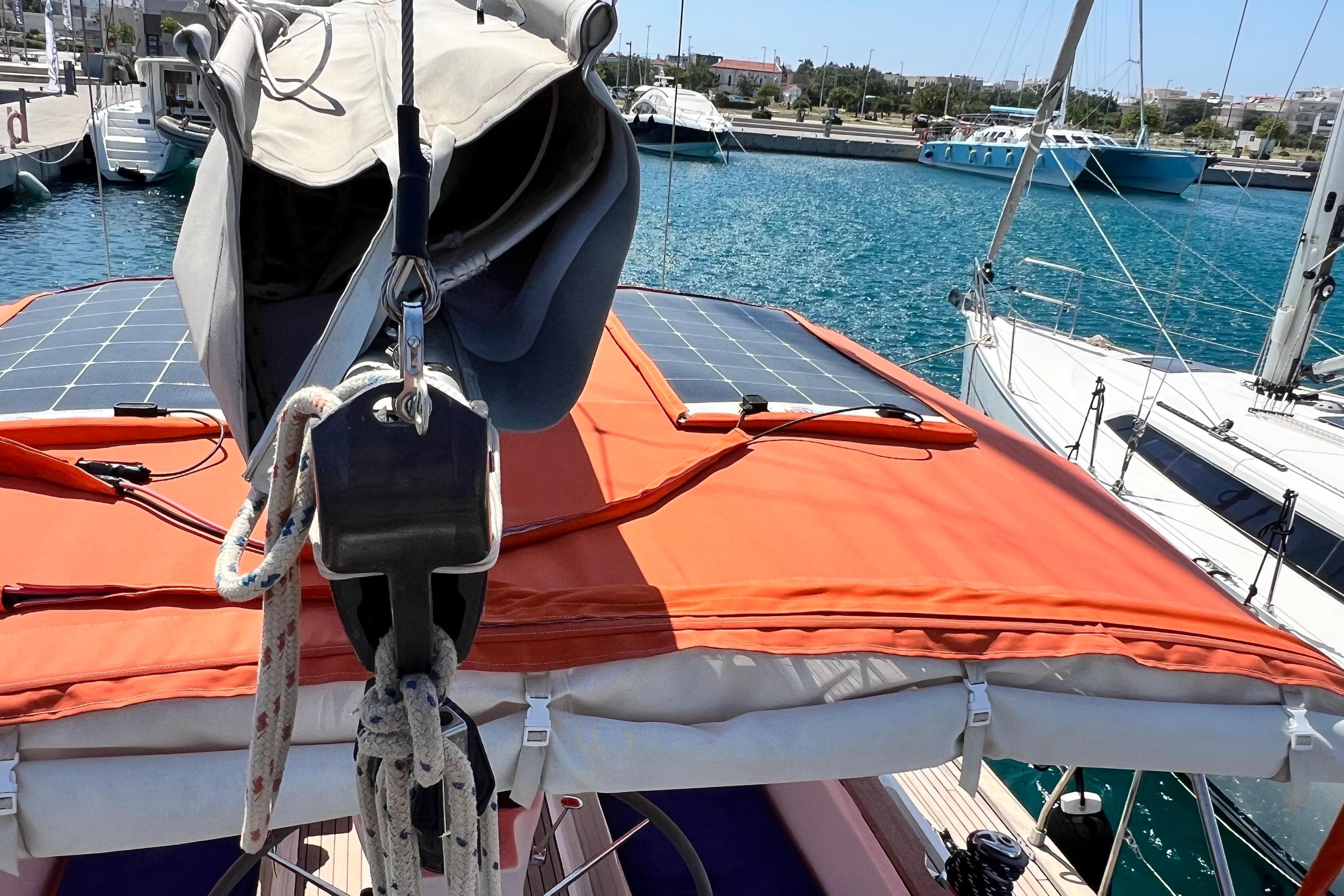 Sailboat Bavaria 40 Ocean 2003 with solar panels docked at marina.