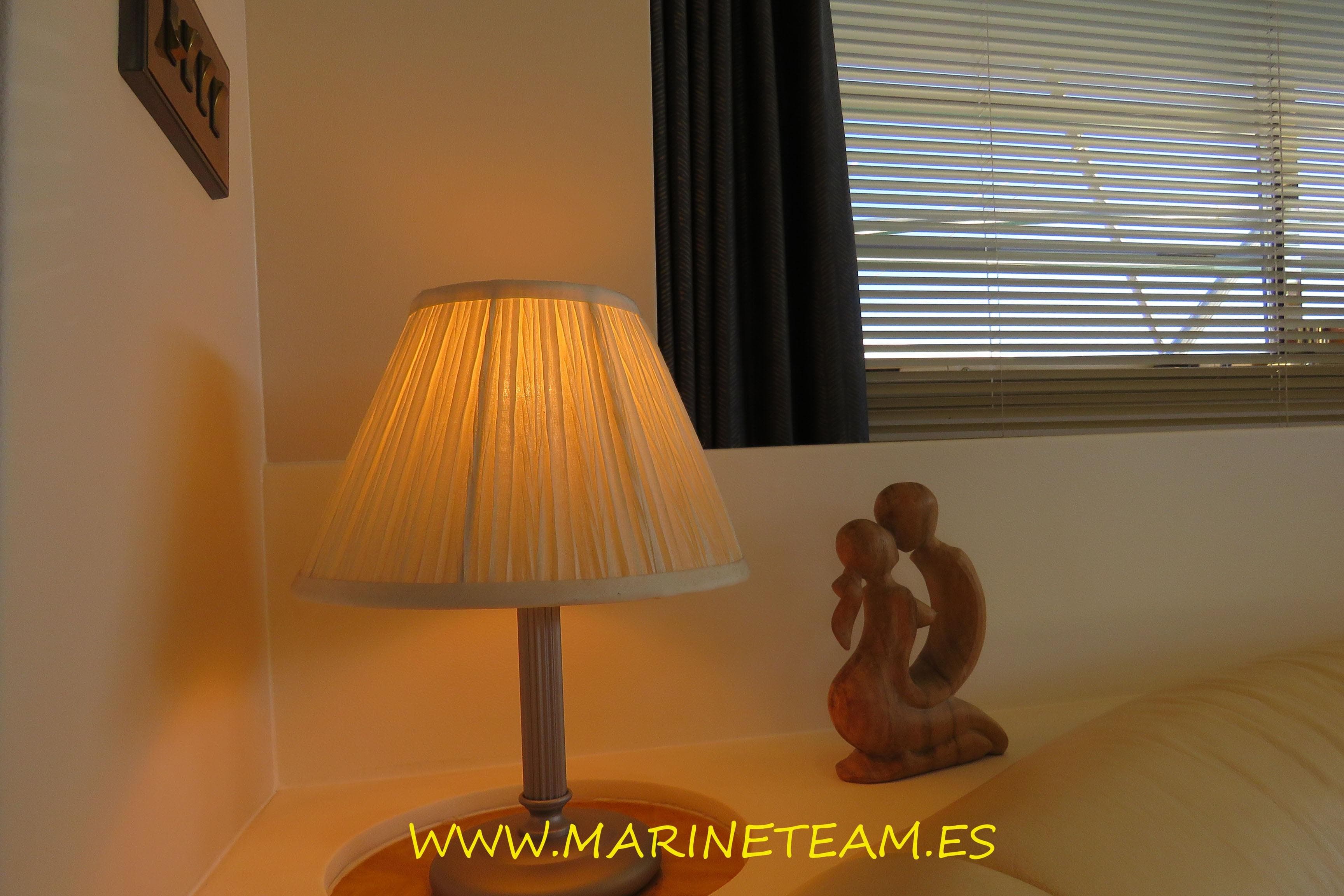 Cozy yacht interior with lamp and wooden sculpture, Princess 60, 1995 model.