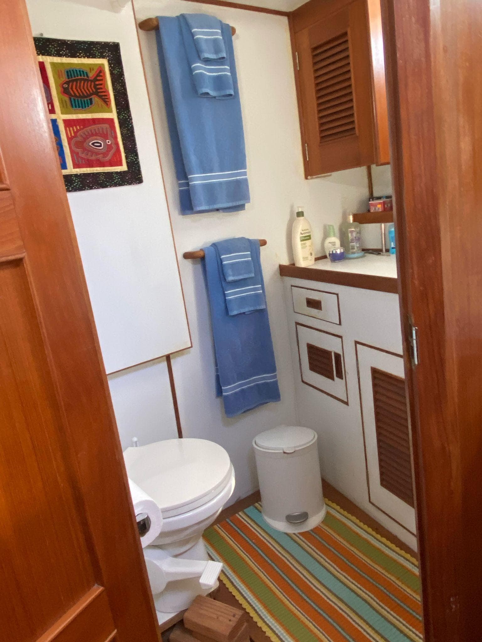 Bathroom interior of 1980 Ocean Alexander 40 Double Cabin with wooden accents and colorful decor.