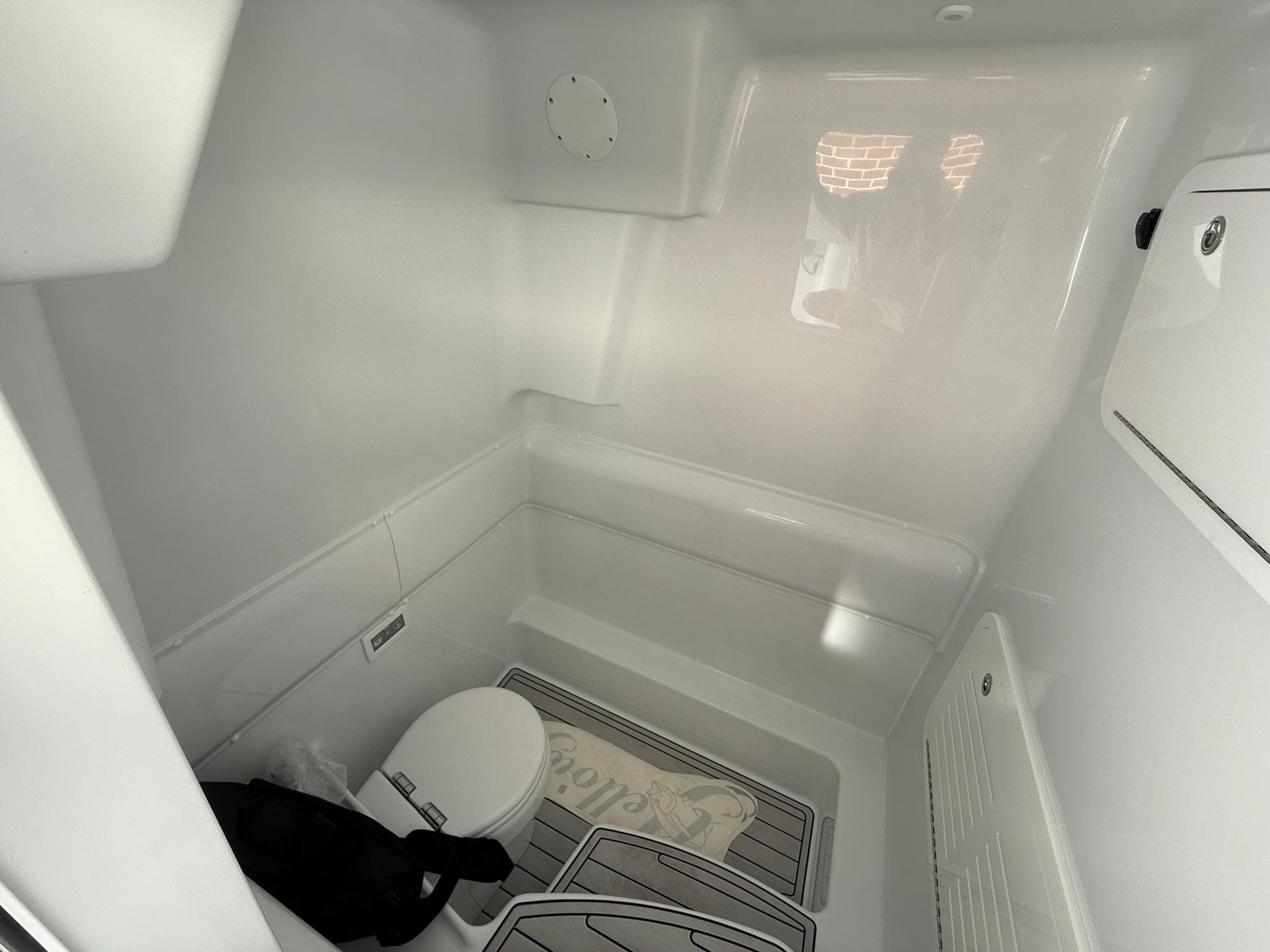 2025 Yellowfin 39 Offshore boat interior with toilet and storage space.