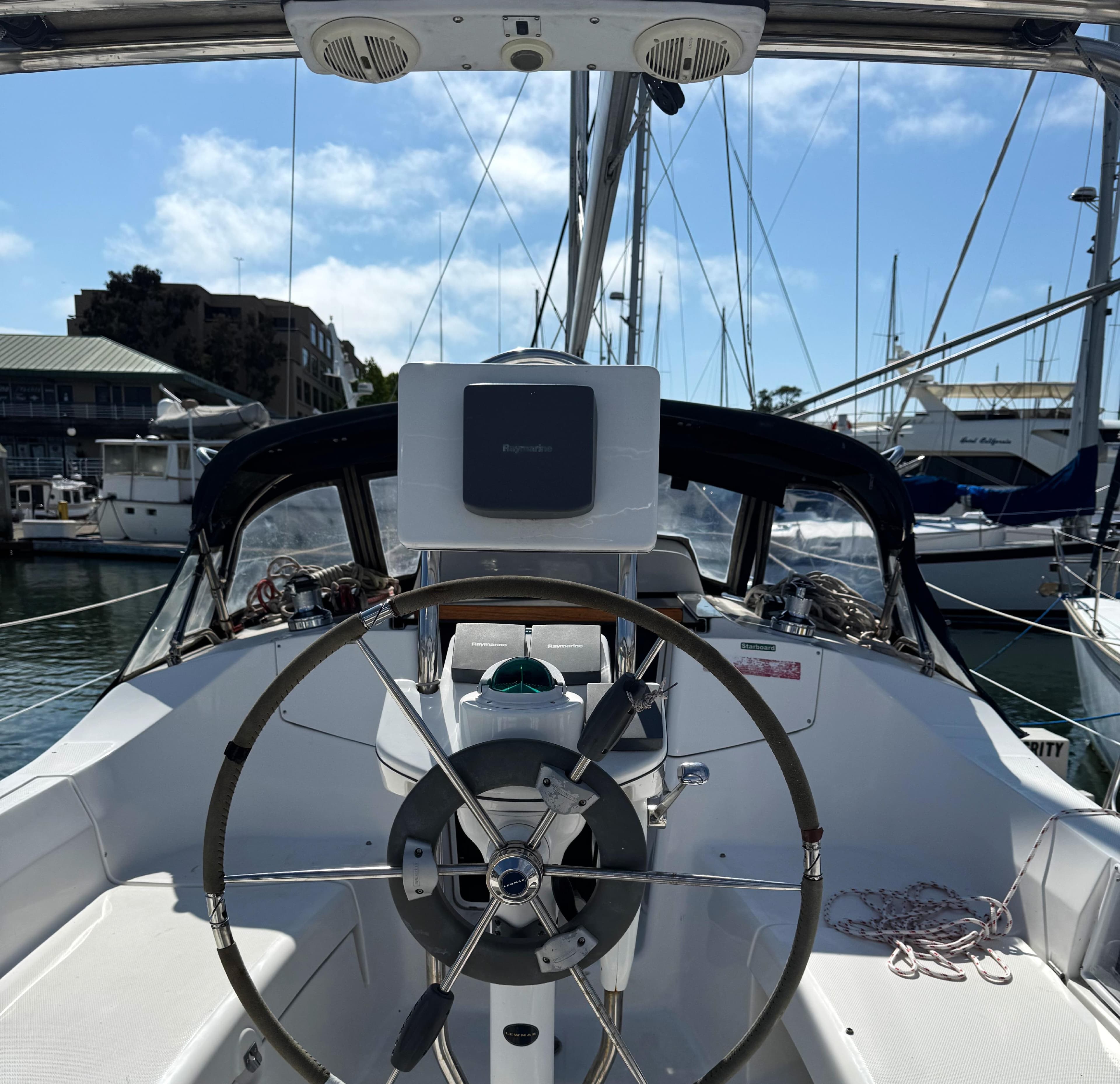 Cockpit view of a 2005 Hunter 33 sailboat with steering wheel and navigation equipment.