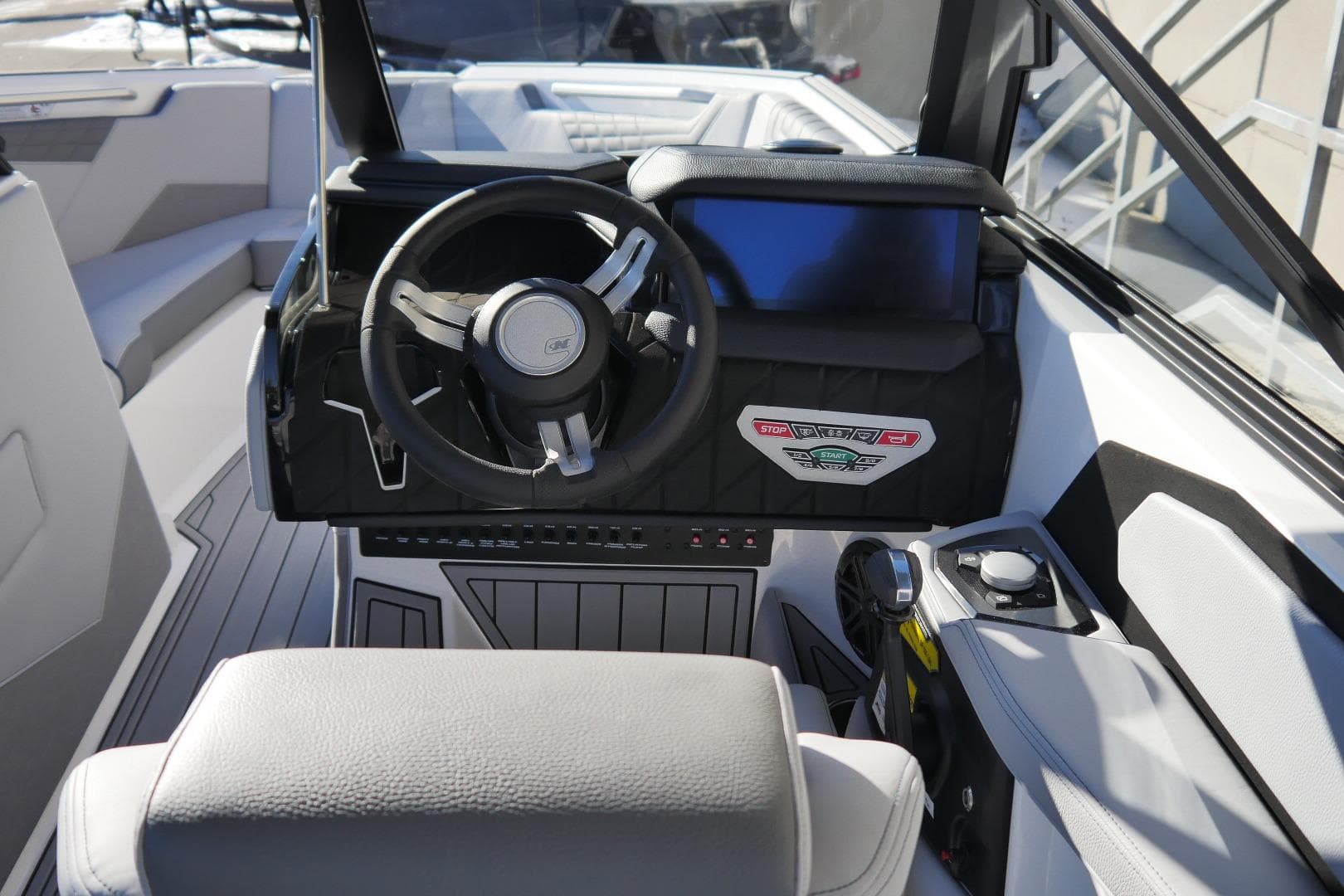 2026 Nautique Super Air Nautique S23 boat cockpit with modern steering and controls.