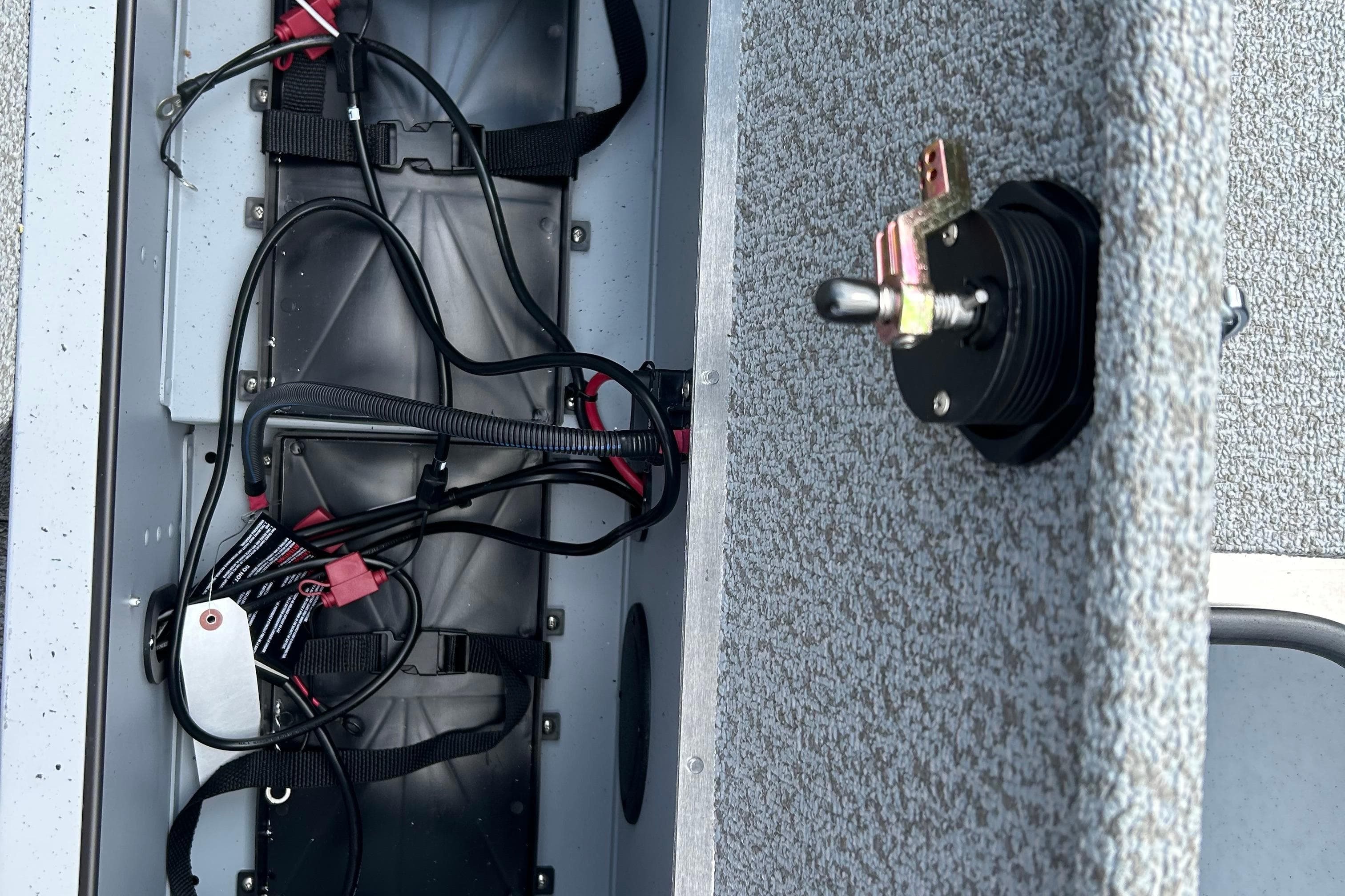 Interior wiring of 2026 Lund 2075 Alaskan Sport boat, featuring electrical components and toggle switch.