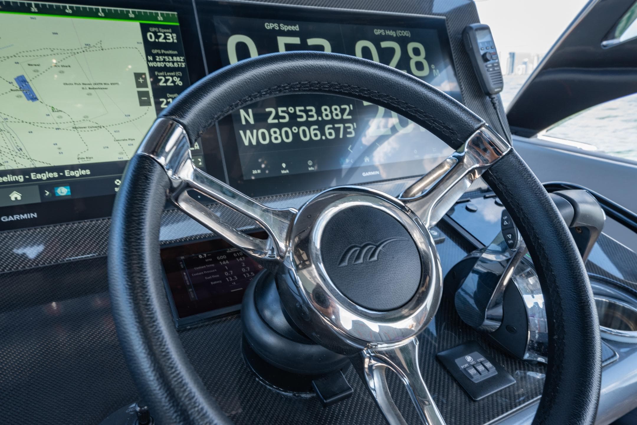 Steering wheel and dashboard of 2022 Midnight Express 37' Open boat with GPS display.
