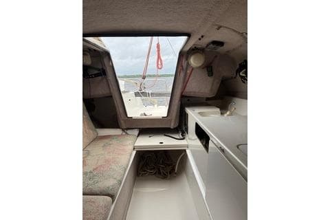 Interior of 1994 Corsair F24 MKI sailboat with seating and compact kitchenette.