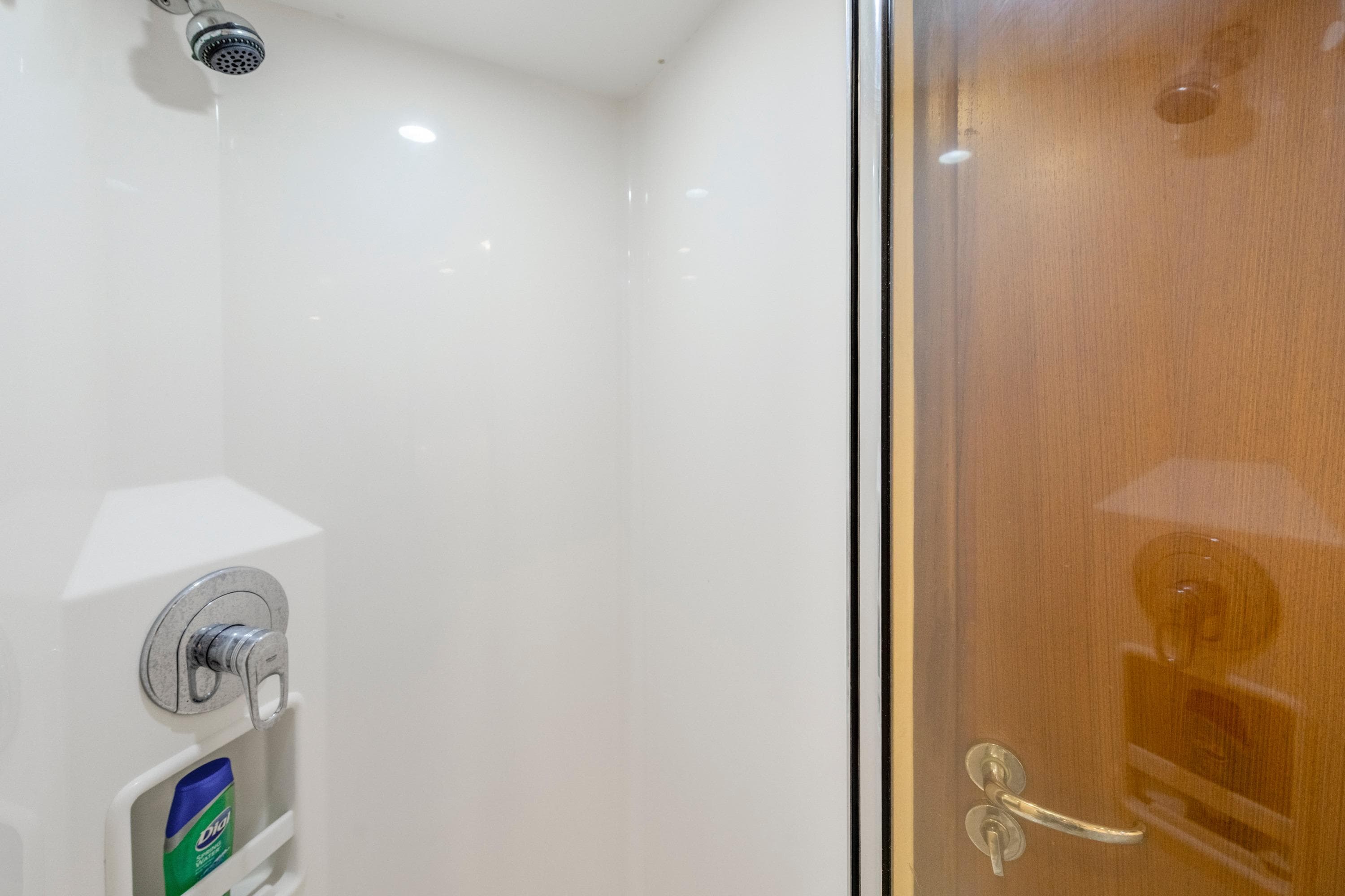 Shower area inside 2005 Cabo 40 Flybridge yacht, featuring sleek design and modern fixtures.
