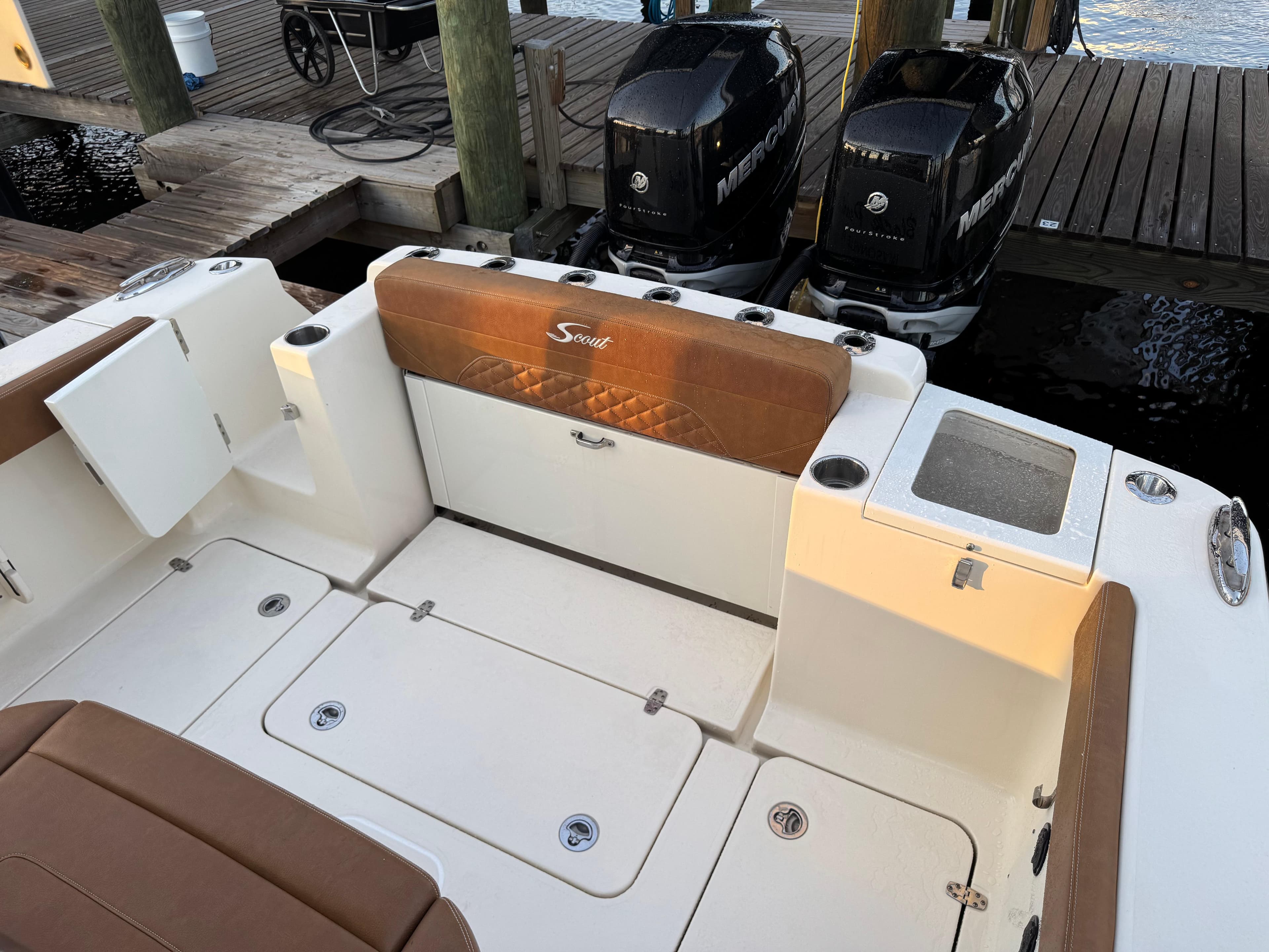 2021 Scout 330 LXF boat interior with twin Mercury engines at dock.