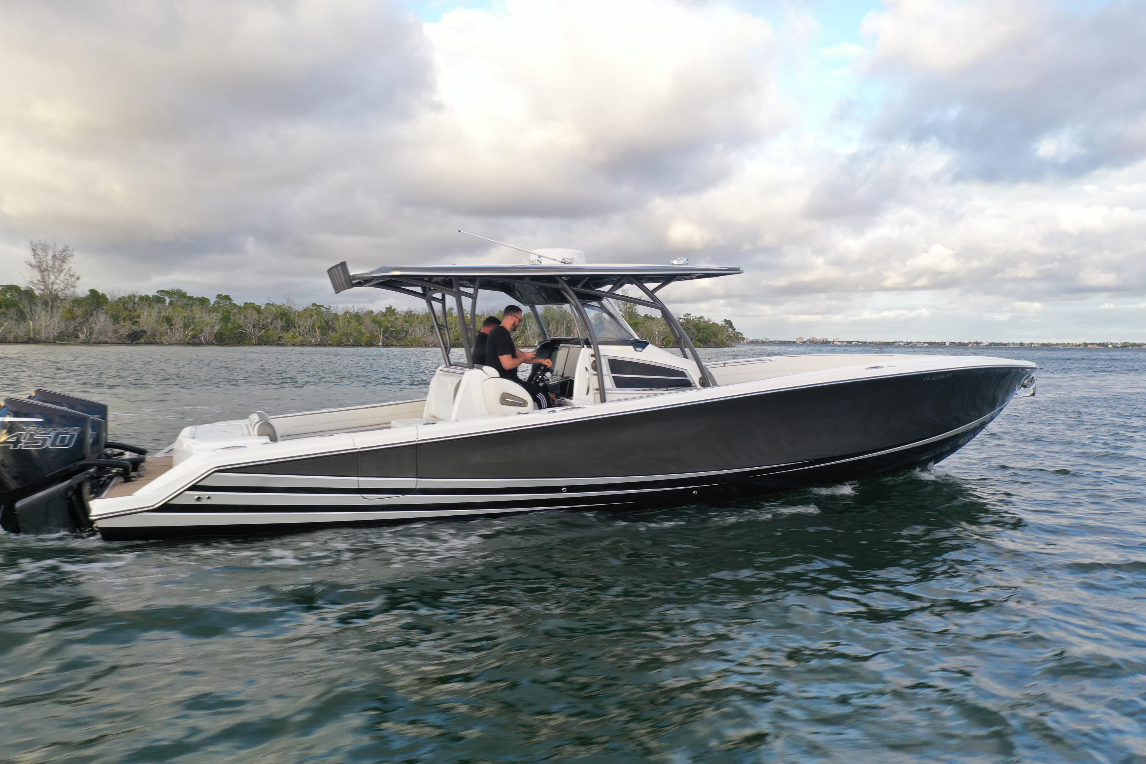 2021 Nor-Tech 390 Sport Center Console boat cruising on water under cloudy sky.