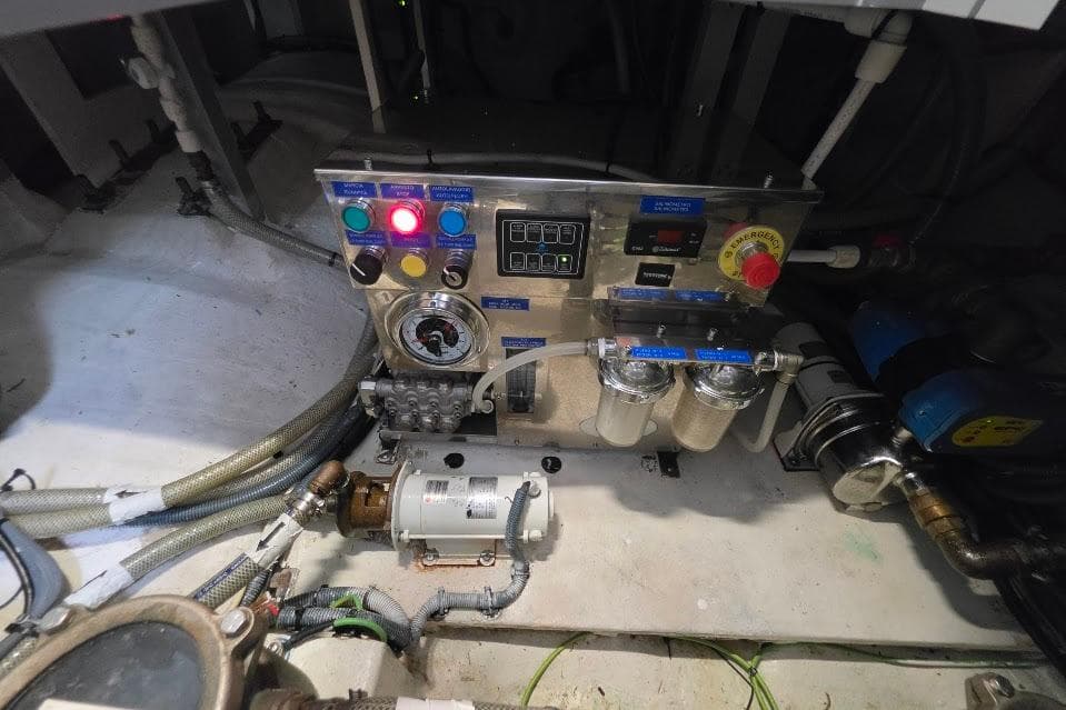 Engine room of 2024 Sirena 58 Flybridge MY yacht, featuring control panel and machinery.