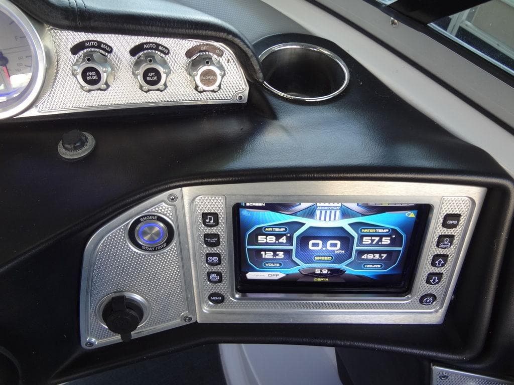 2013 MasterCraft X55 boat dashboard with touchscreen display and control knobs.