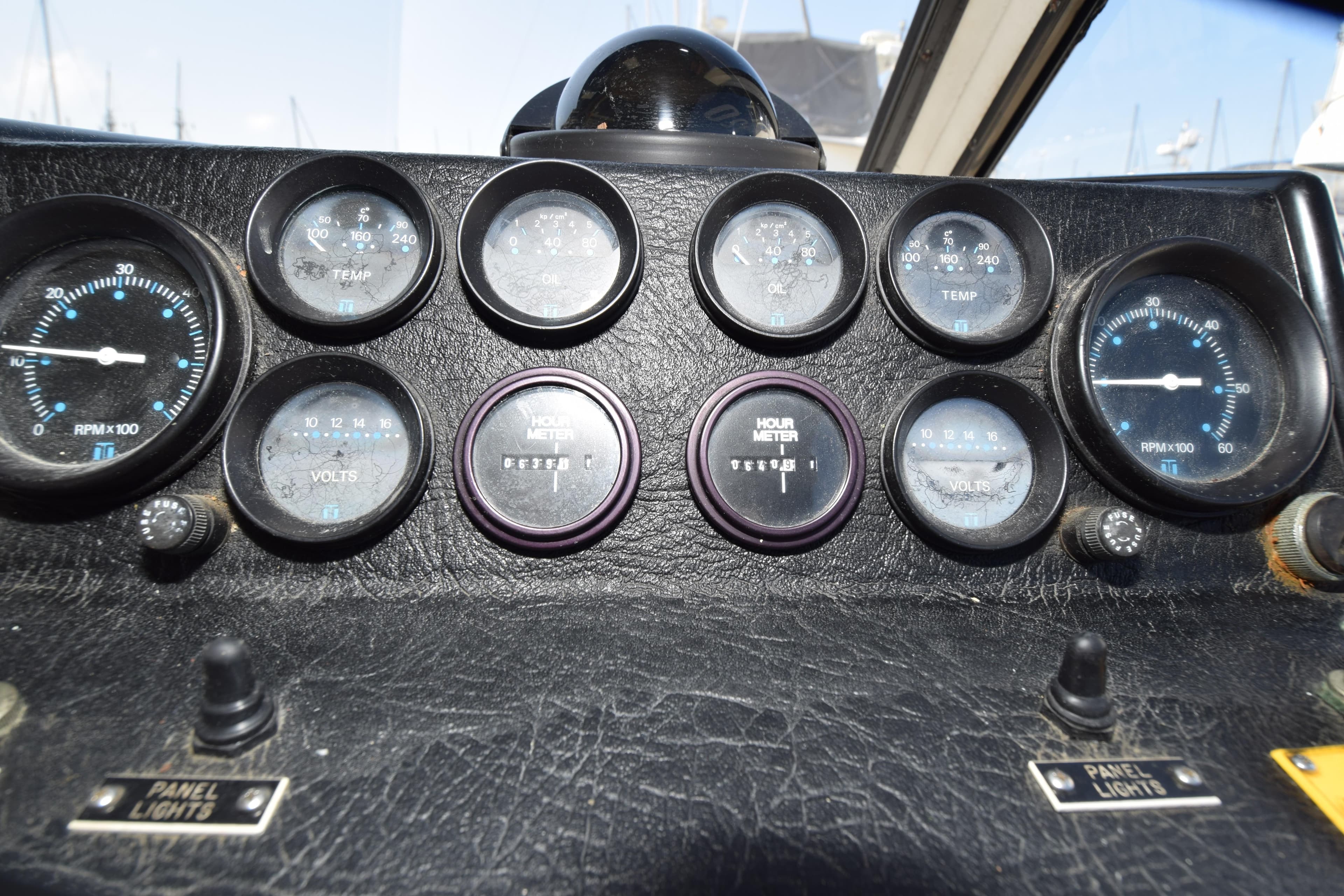 Instrument panel of a 1988 Mediterranean 38 Convertible boat with gauges and controls.