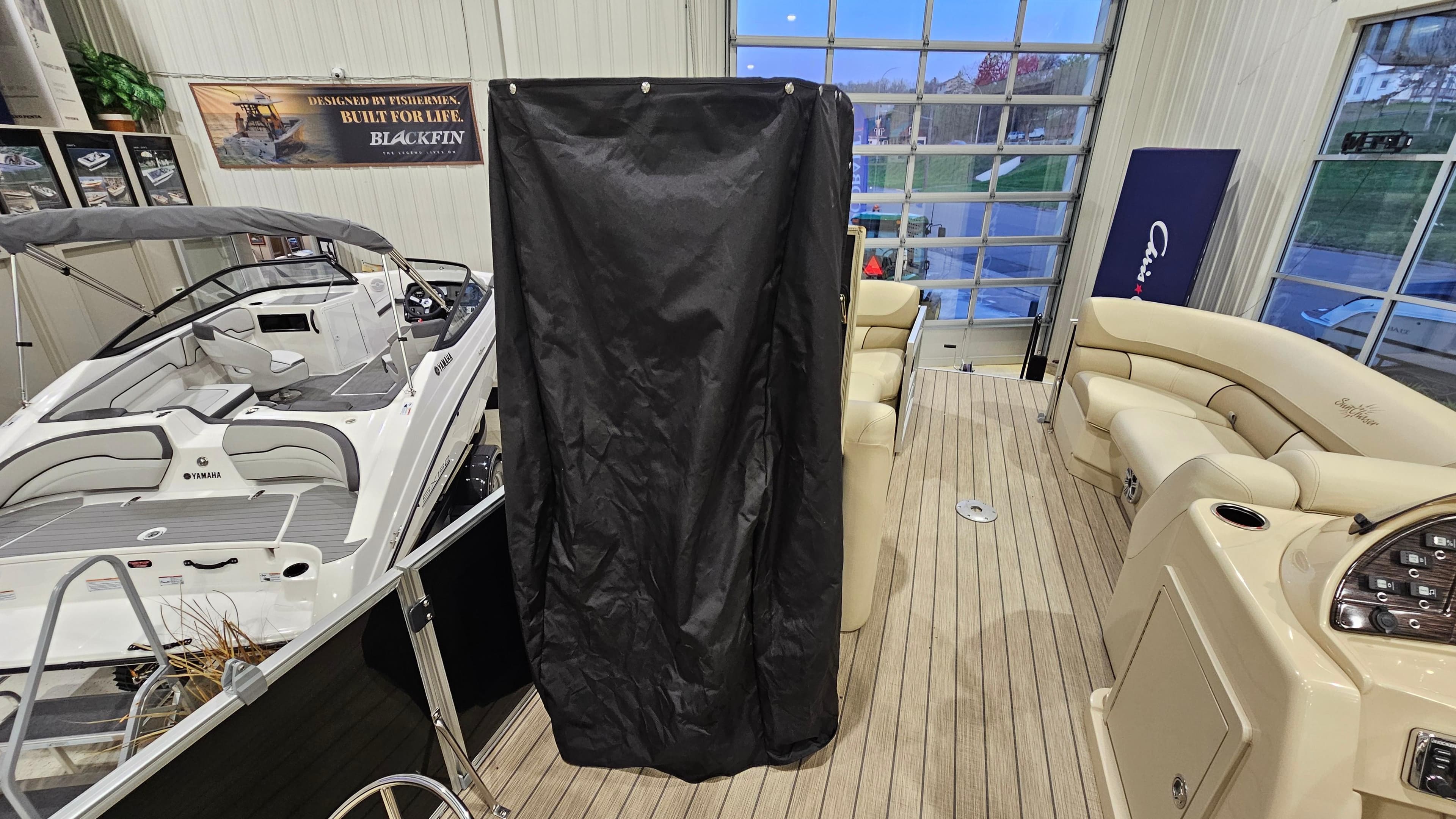 2019 SunChaser Eclipse 8525 Entertainer boat in showroom with luxury seating and modern design.