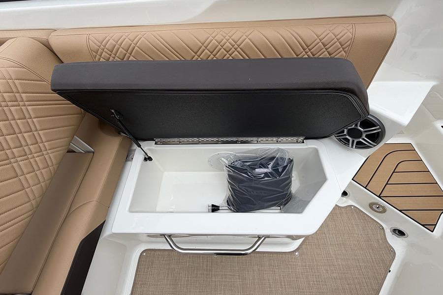 2026 Sea Ray SDX 270 Outboard boat seat storage with beige upholstery and speaker.