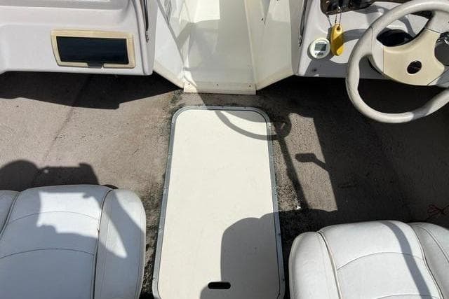 Interior of a 2005 Stingray 180 RX boat with white seats.