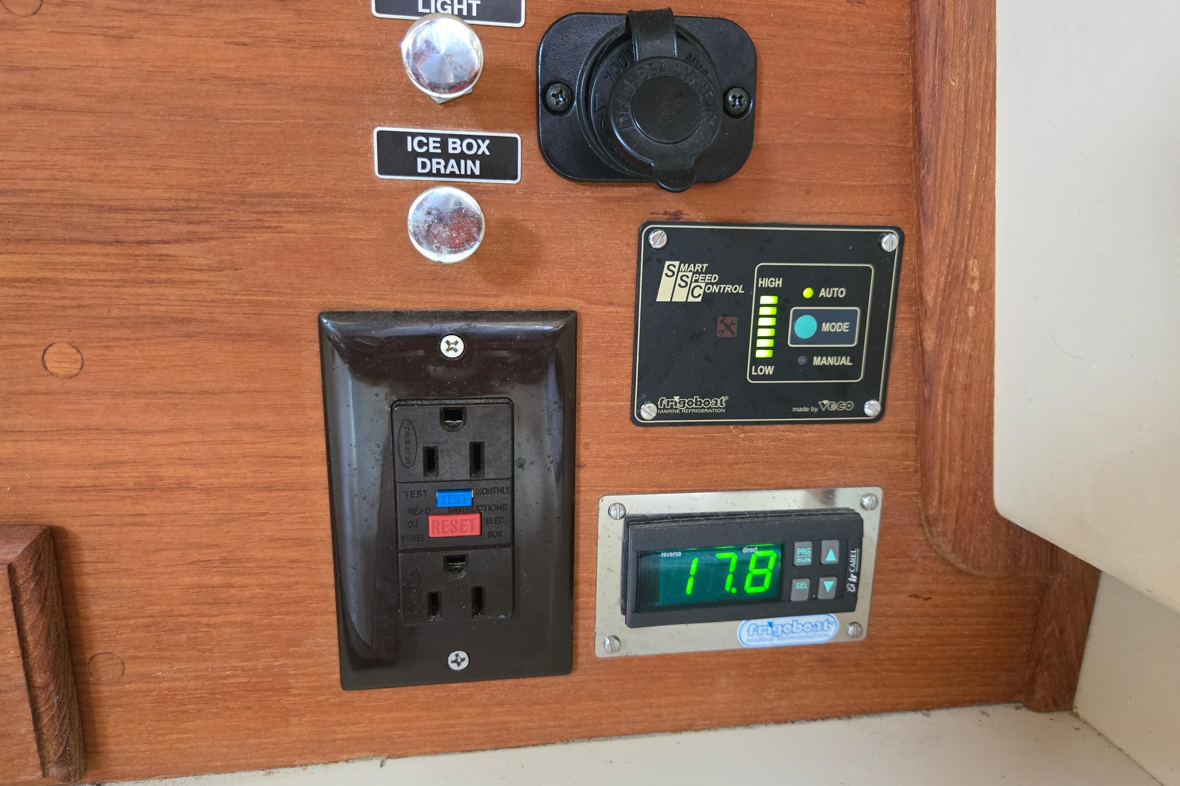 Control panel on 2006 Island Packet 370 sailboat with electrical outlets and speed control.