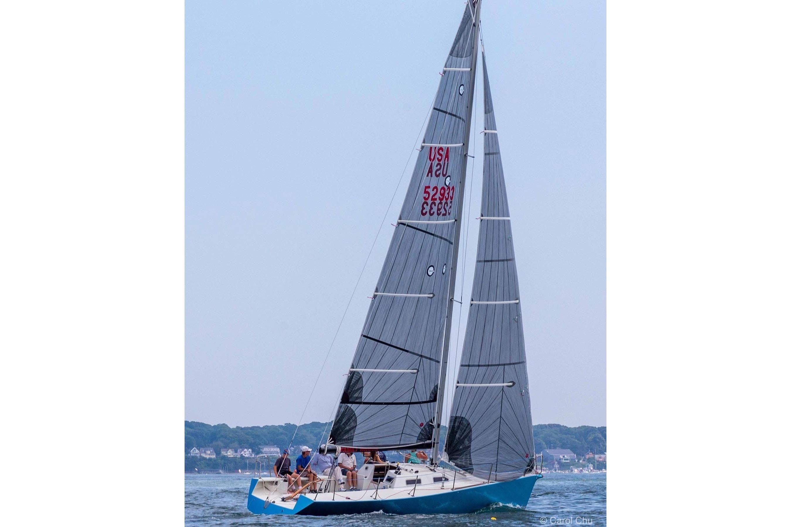 Sailing on a Hallett 33 yacht, 2007 model, with crew on a clear day.