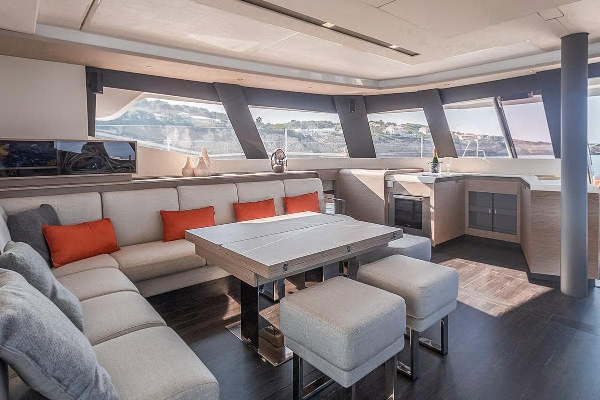 Luxurious interior of 2026 Fountaine Pajot Samana 59 yacht with modern seating and panoramic windows.