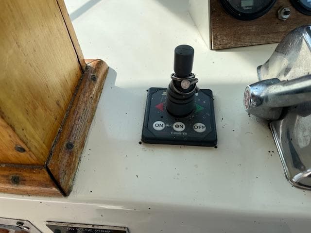 Control panel of a 1977 Hatteras 43 Double Cabin boat with toggle switch and lever.