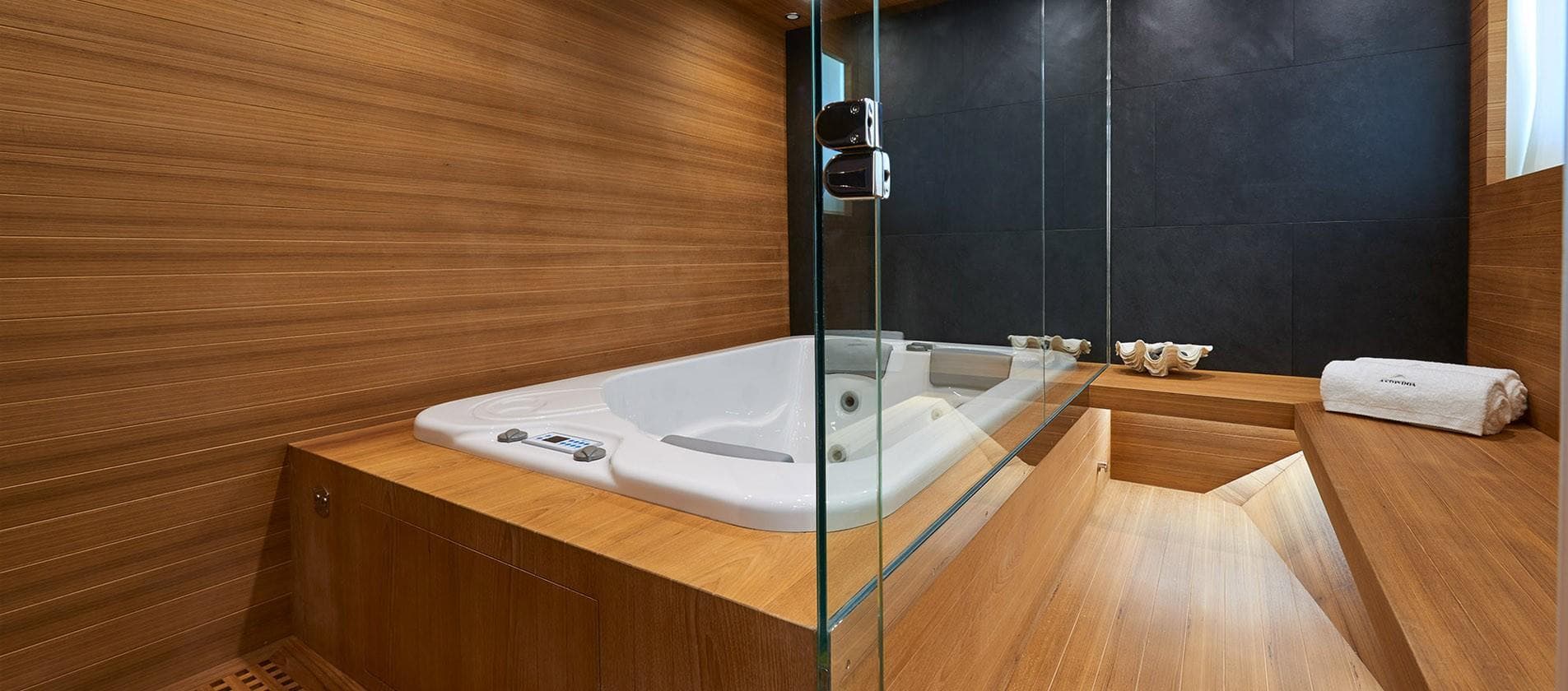 Luxurious bathroom with wooden accents on the 2023 Astondoa 100 Century yacht.