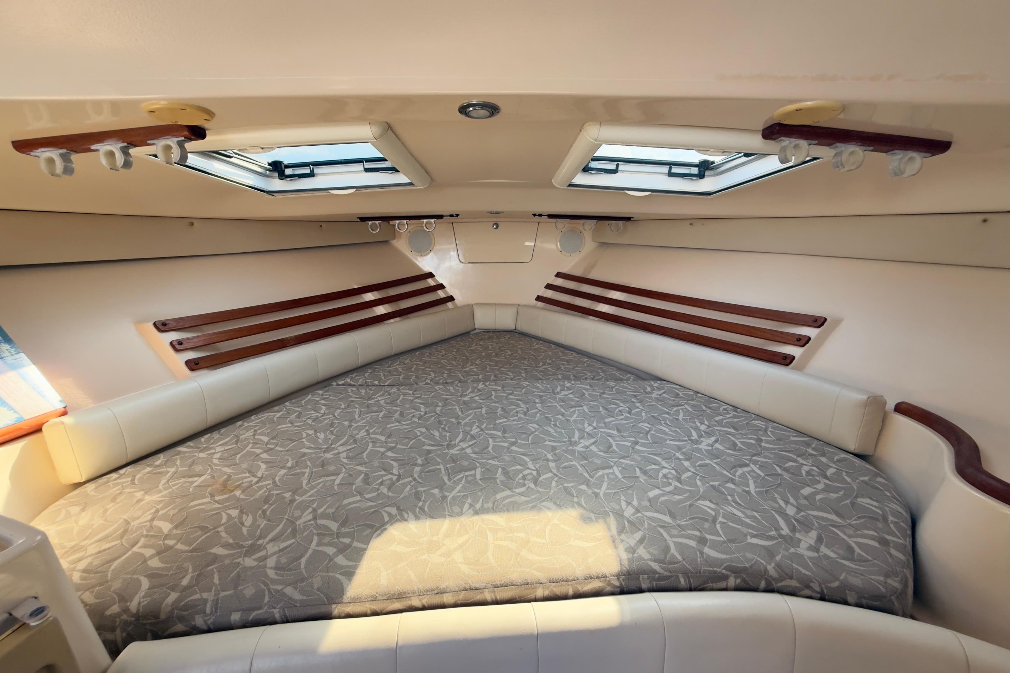 2005 Grady-White Express 330 cabin interior with bed and skylights.