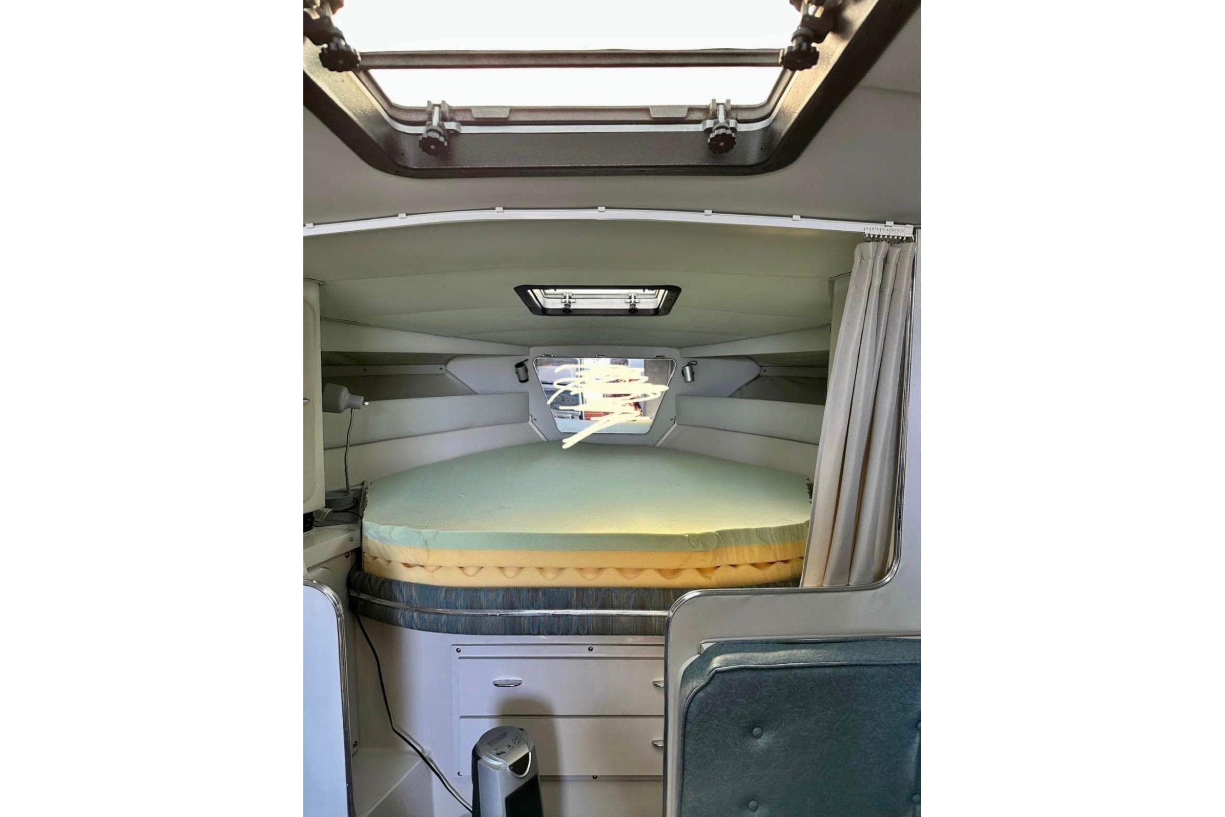 Interior cabin of 1987 Wellcraft 3400 Gran Sport boat with bed and storage.