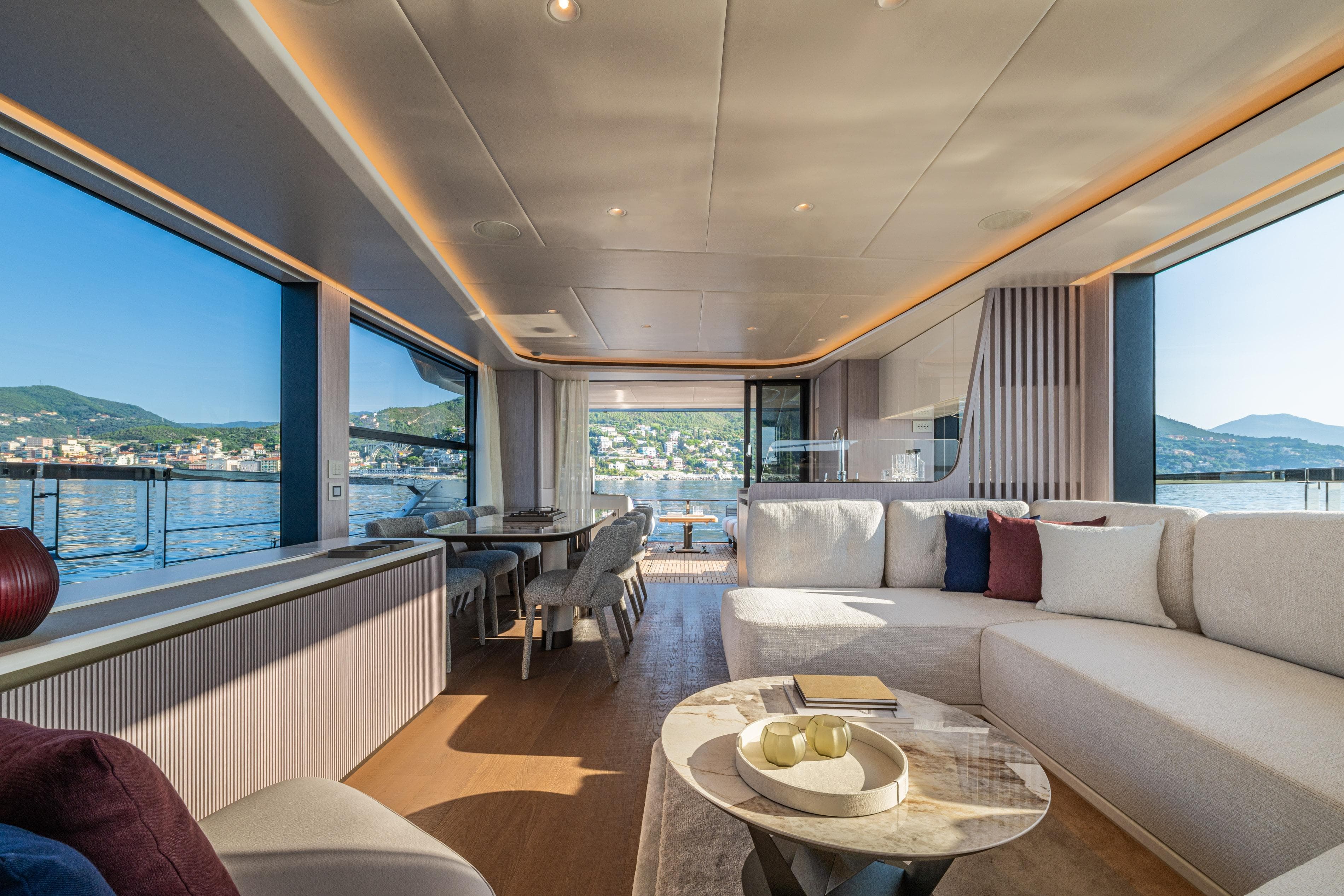 Luxurious interior of 2026 Absolute 62' Navetta yacht with panoramic windows and elegant furnishings.