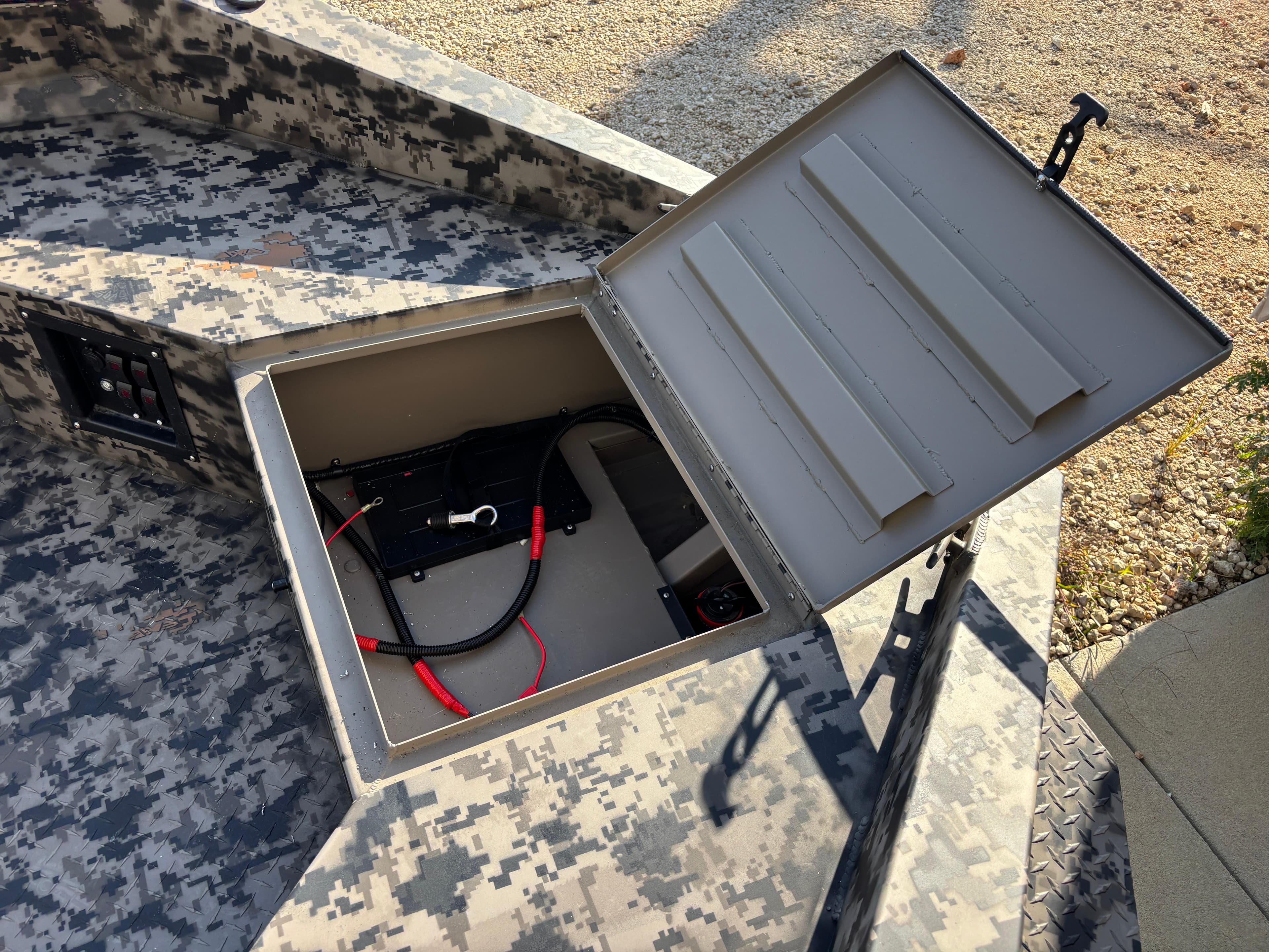 Open storage compartment in 2025 Edge Duck Boats 756DB with camouflage design.