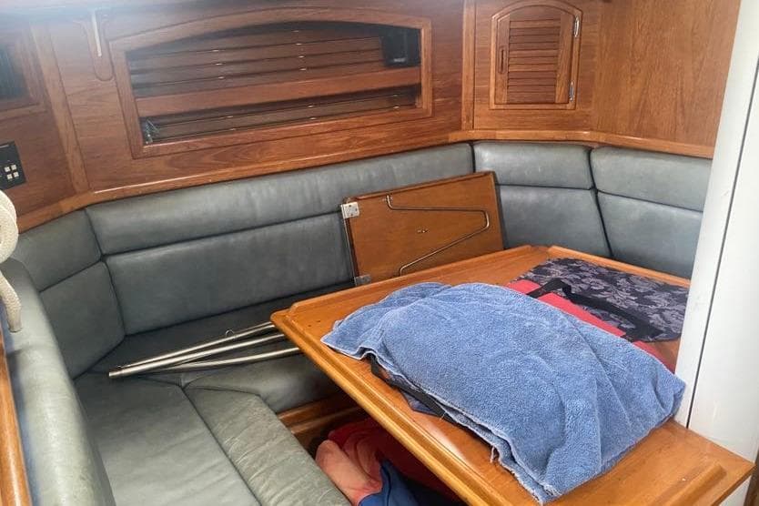 Interior of 1993 Pacific Seacraft 44 Voyager sailboat with wooden furnishings and seating area.