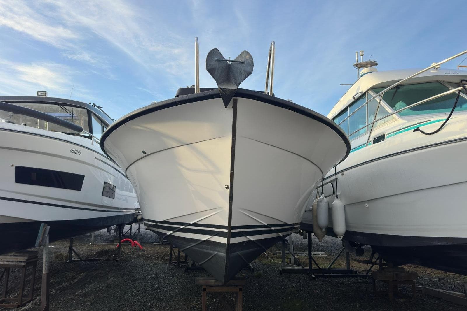2012 Targa 27.1 GT boat on dry dock between two other vessels.