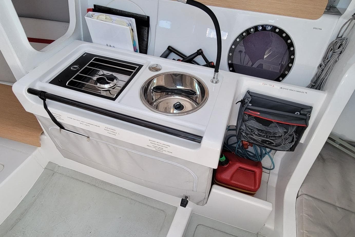 Compact galley in 2020 Dehler 30 OD sailboat with stove, sink, and storage.