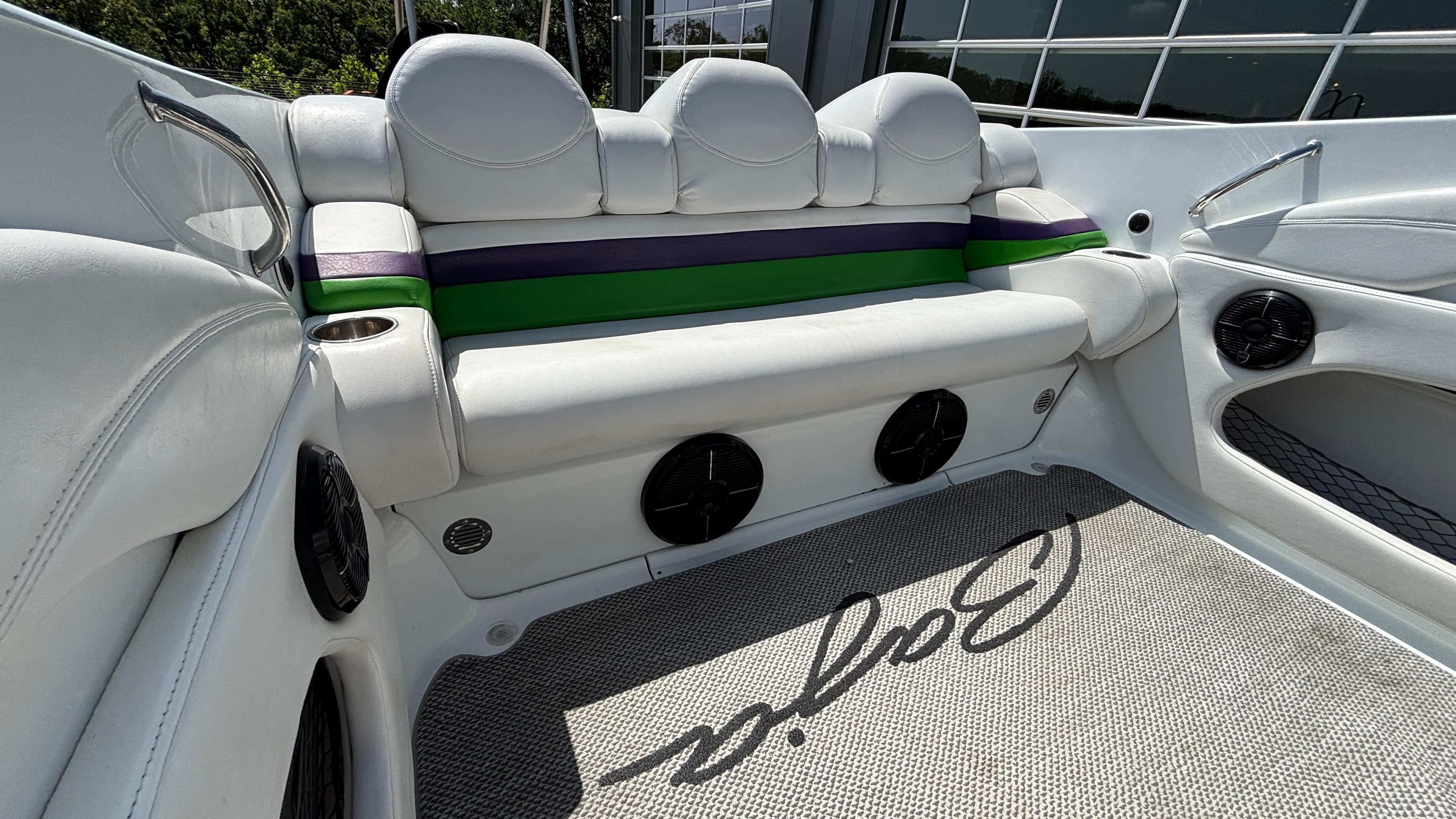 2005 Baja 33 Outlaw boat interior with white seating and colorful accents.