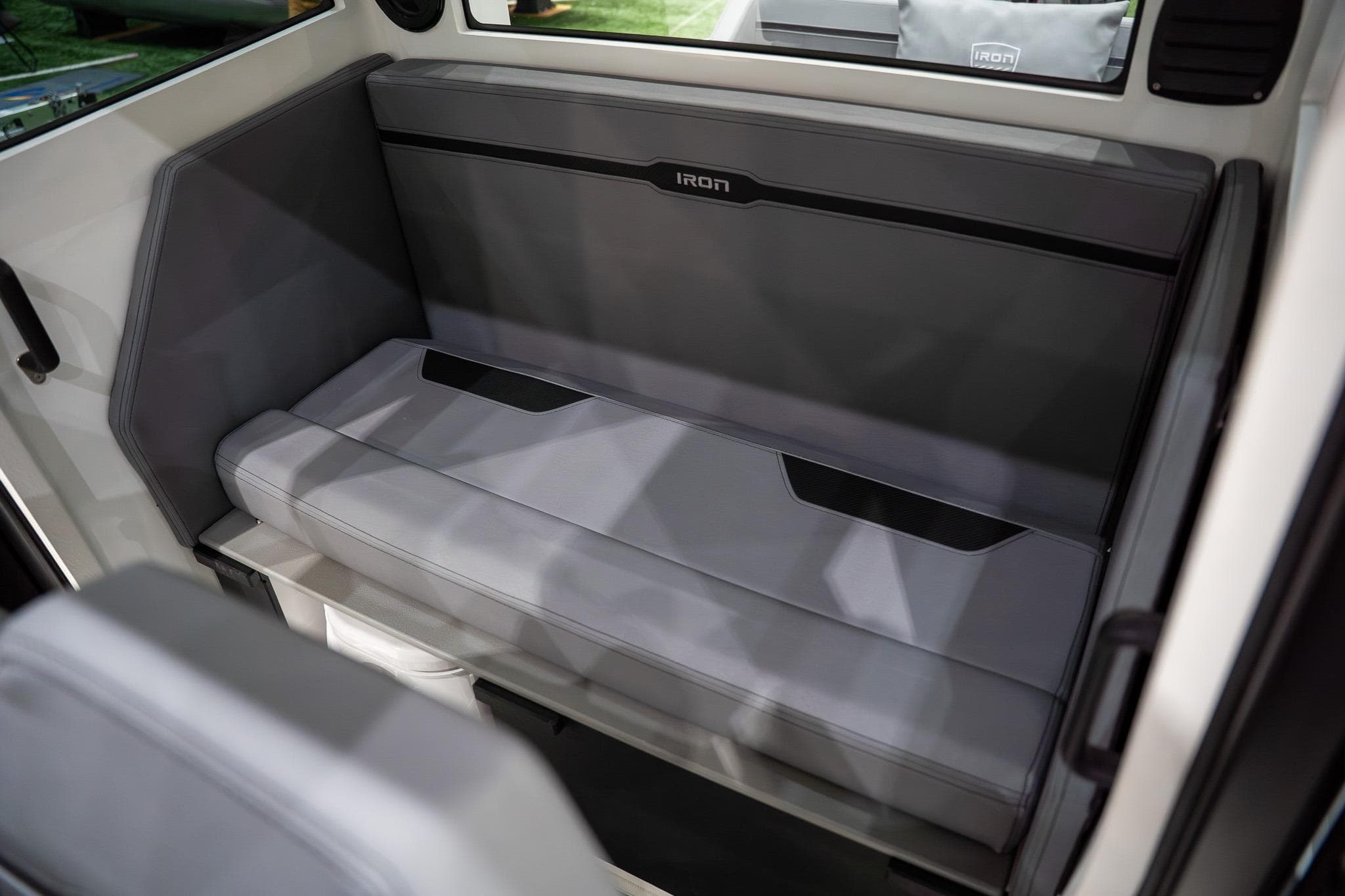 2026 Iron 907 Coupe interior seating with sleek, modern design and gray upholstery.