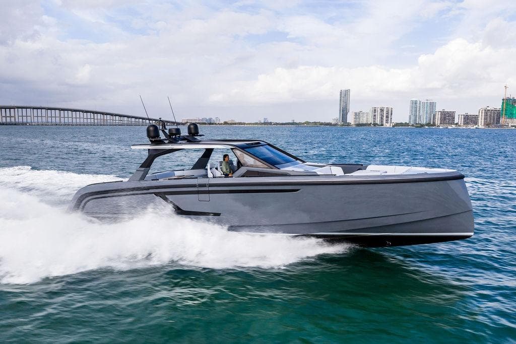 2024 Vanquish Yachts VQ55 cruising on water near city skyline.