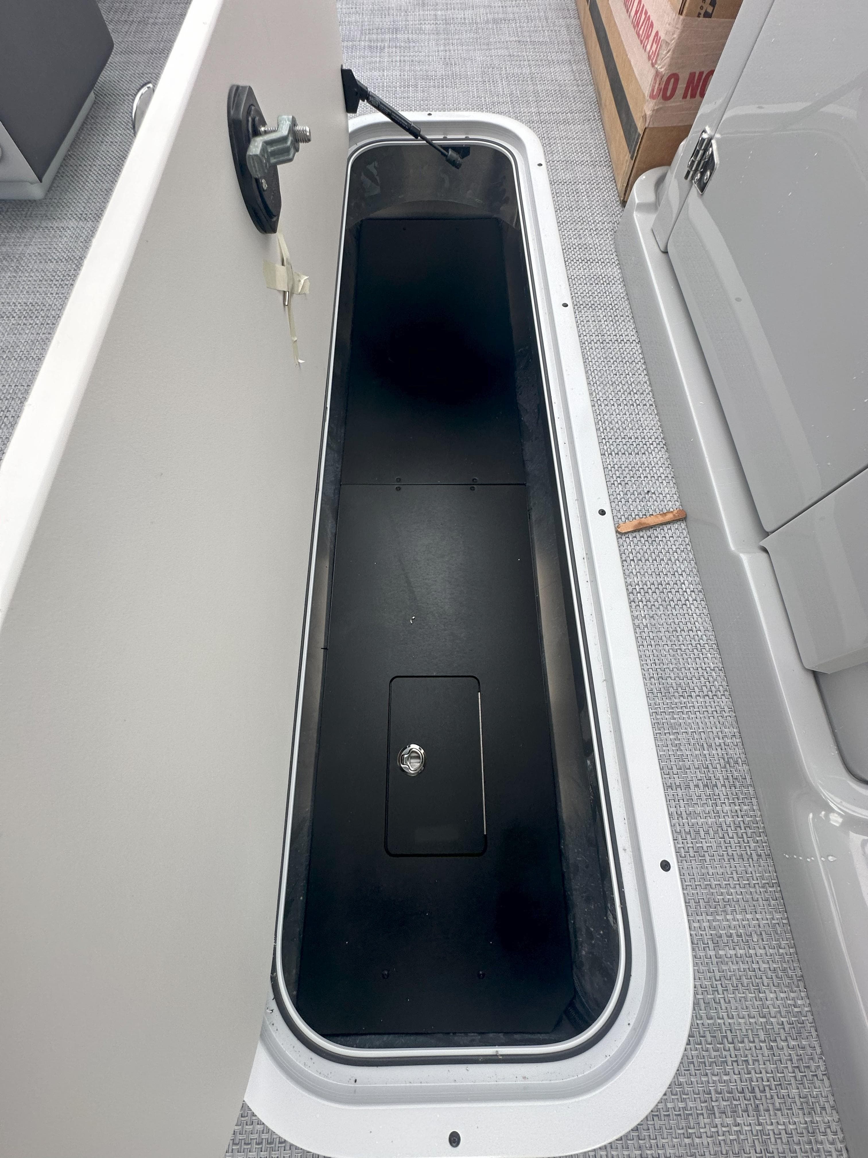Open storage compartment on 2026 Flagship D22CU Extended Deck boat.