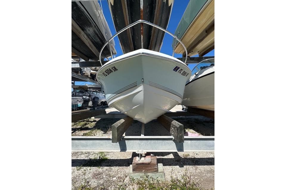 2006 Sea Pro 196 Center Console boat stored on a rack outdoors.