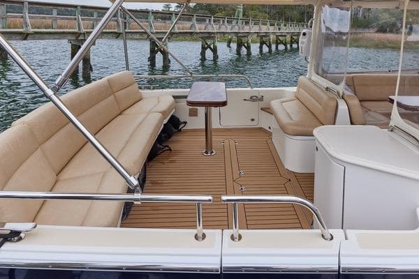 Luxurious 2018 MJM 40z yacht interior with beige seating and wooden deck.