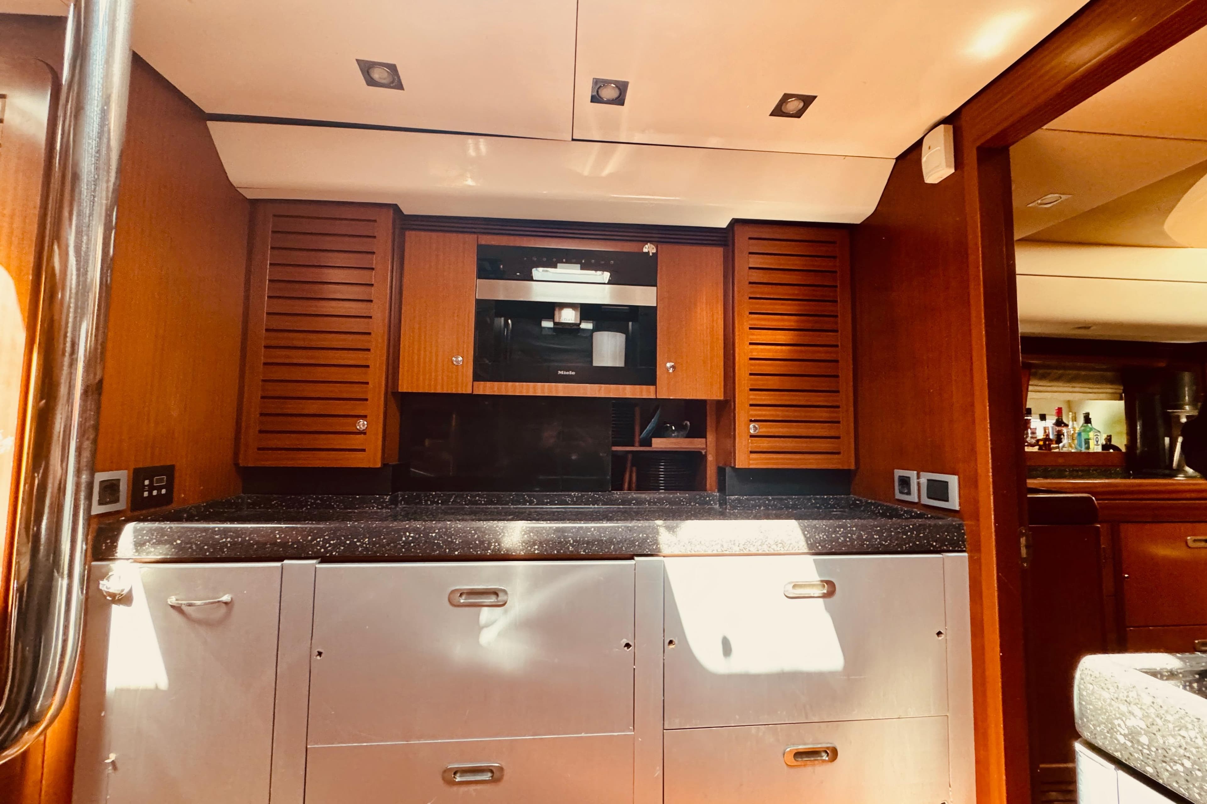 Luxurious Alia Yachts 2010 custom kitchen interior with wooden cabinets and modern appliances.