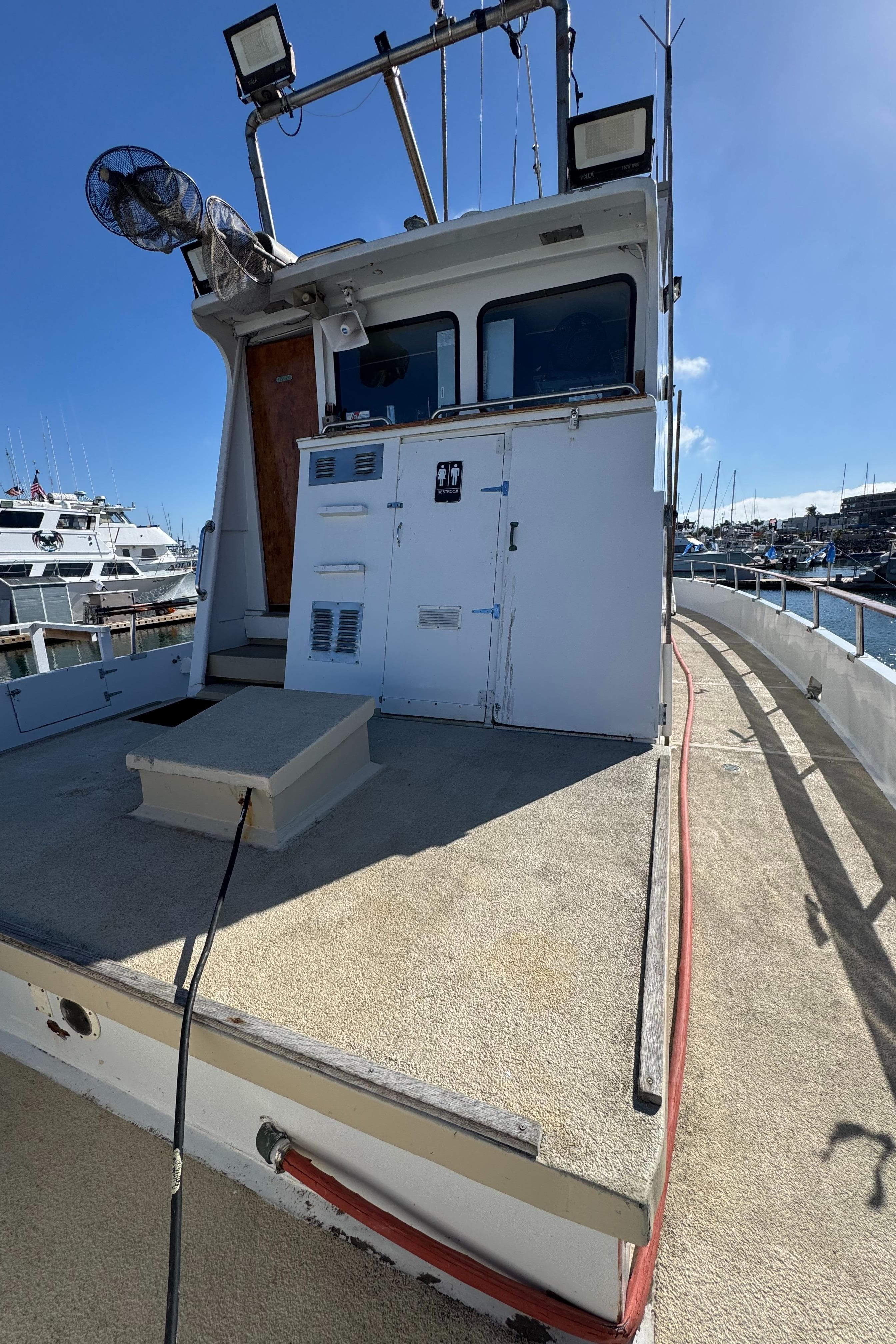 1966 Seaway Commercial Sportfish Vessel docked, featuring spacious deck and cabin, ideal for fishing.