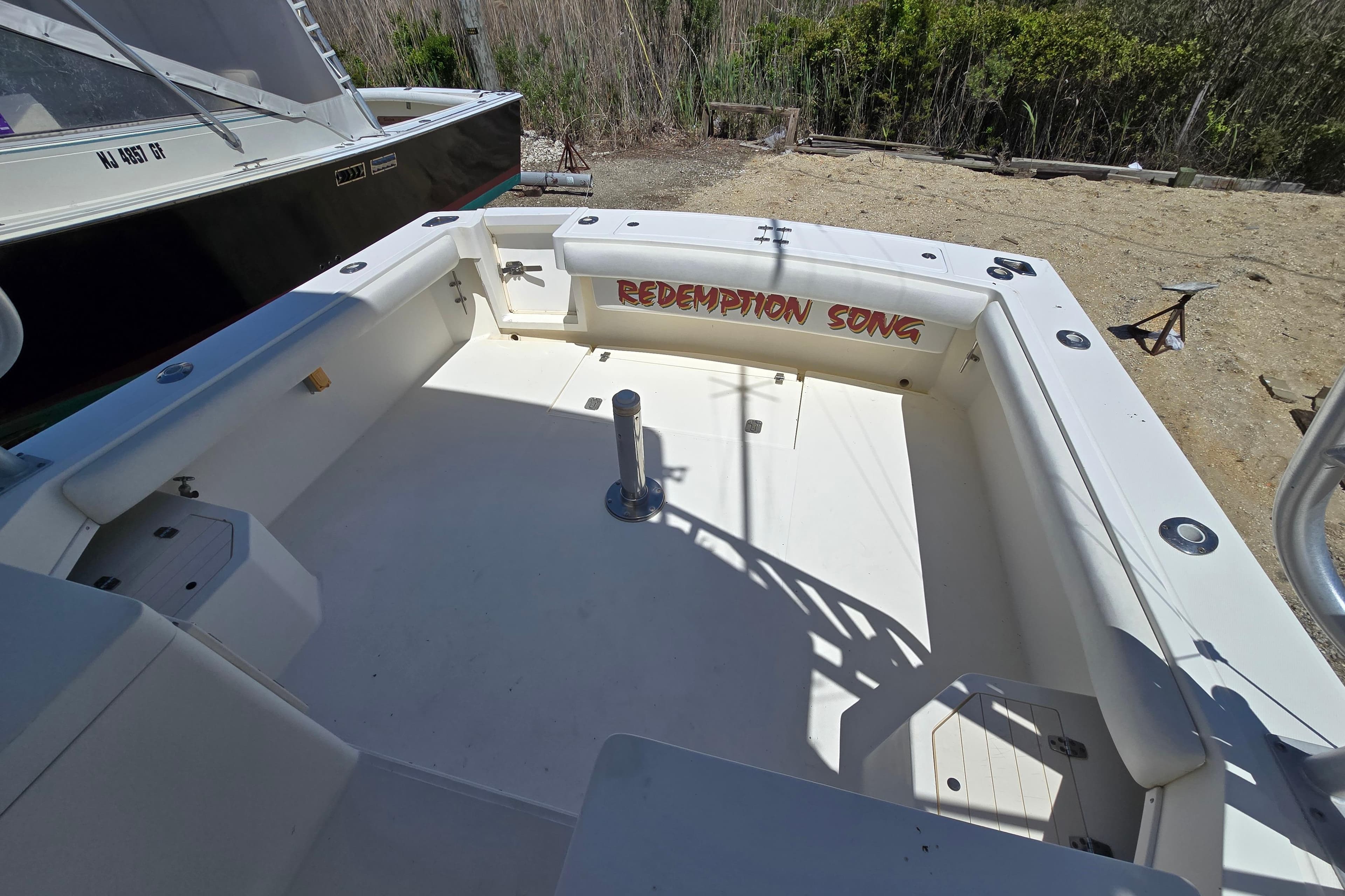 2003 Albemarle 305 Express Fisherman boat deck with "Redemption Song" text.